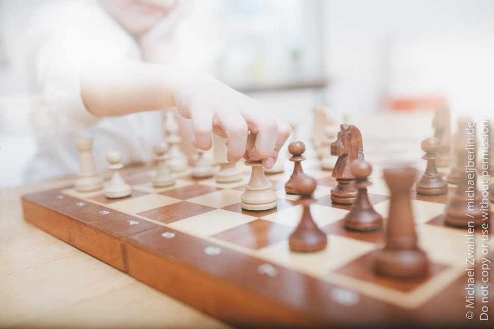 Sigma 35mm F1.4 DG HSM Art sample photo. Boy playing chess, lens flare wide angle shot photography