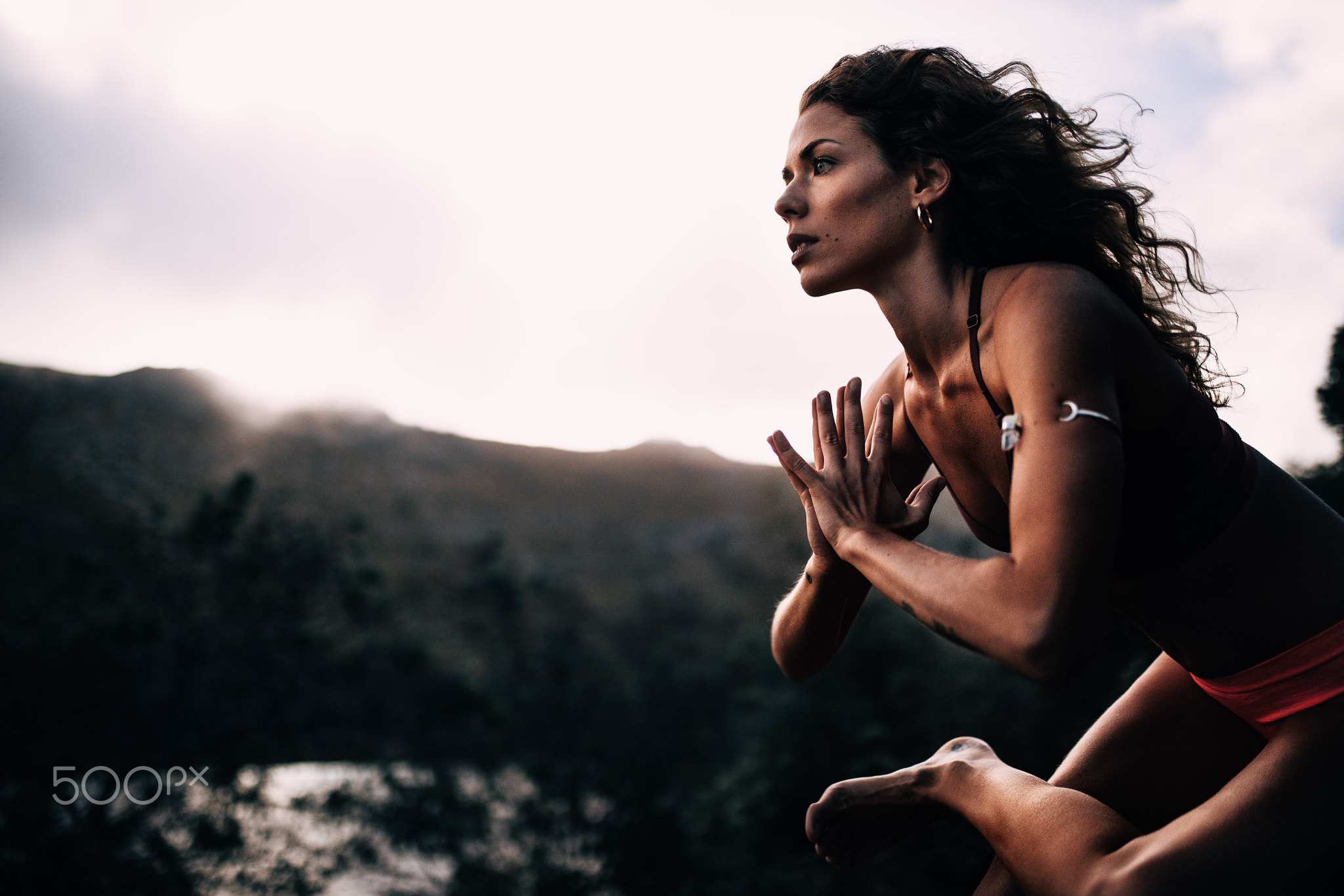 Young strong women doing yoga pose in nature