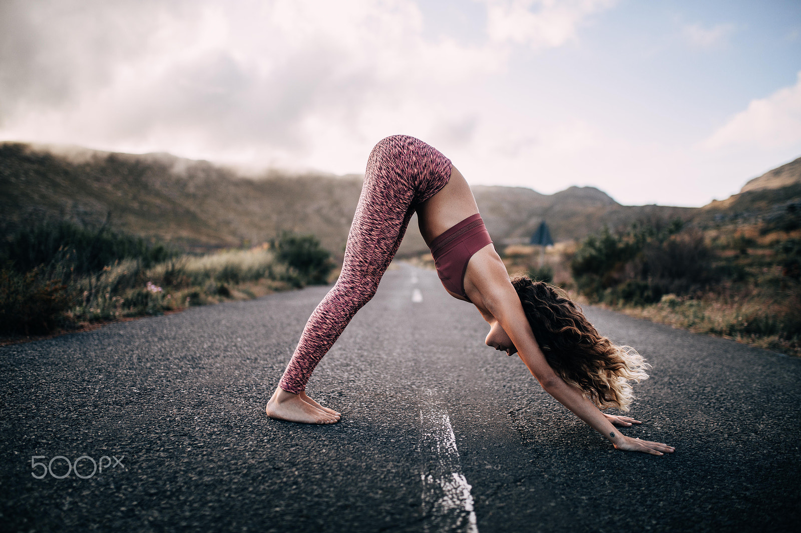 Canon EOS 5DS sample photo. Young female adult practicing yoga on scenic road photography