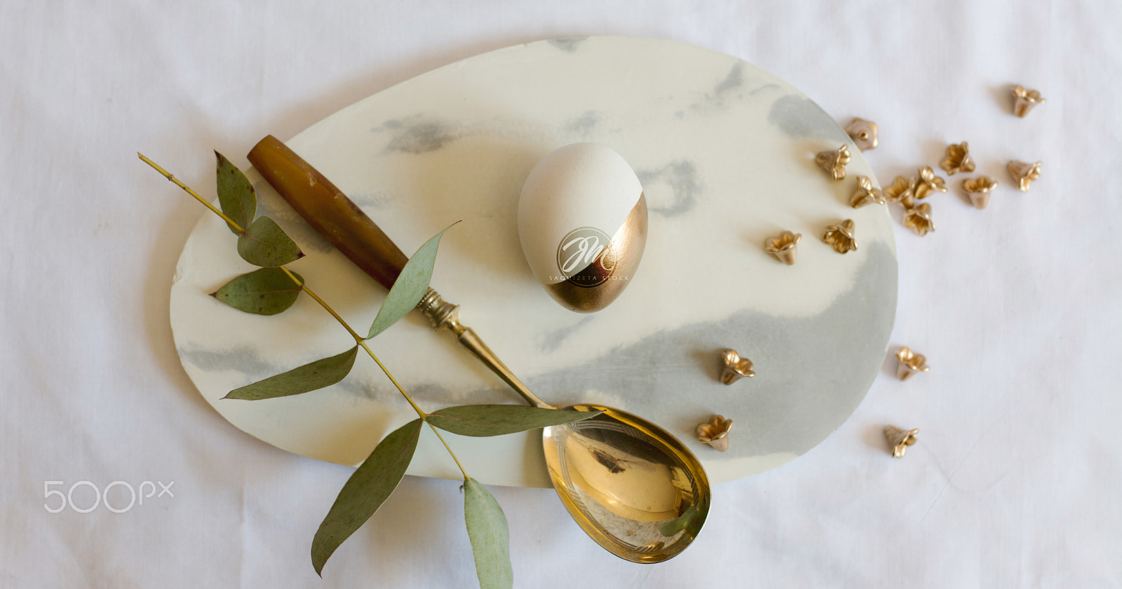 Sigma 35mm F1.4 DG HSM Art sample photo. Easter: place setting, elegant gold and white egg, on marble pla photography