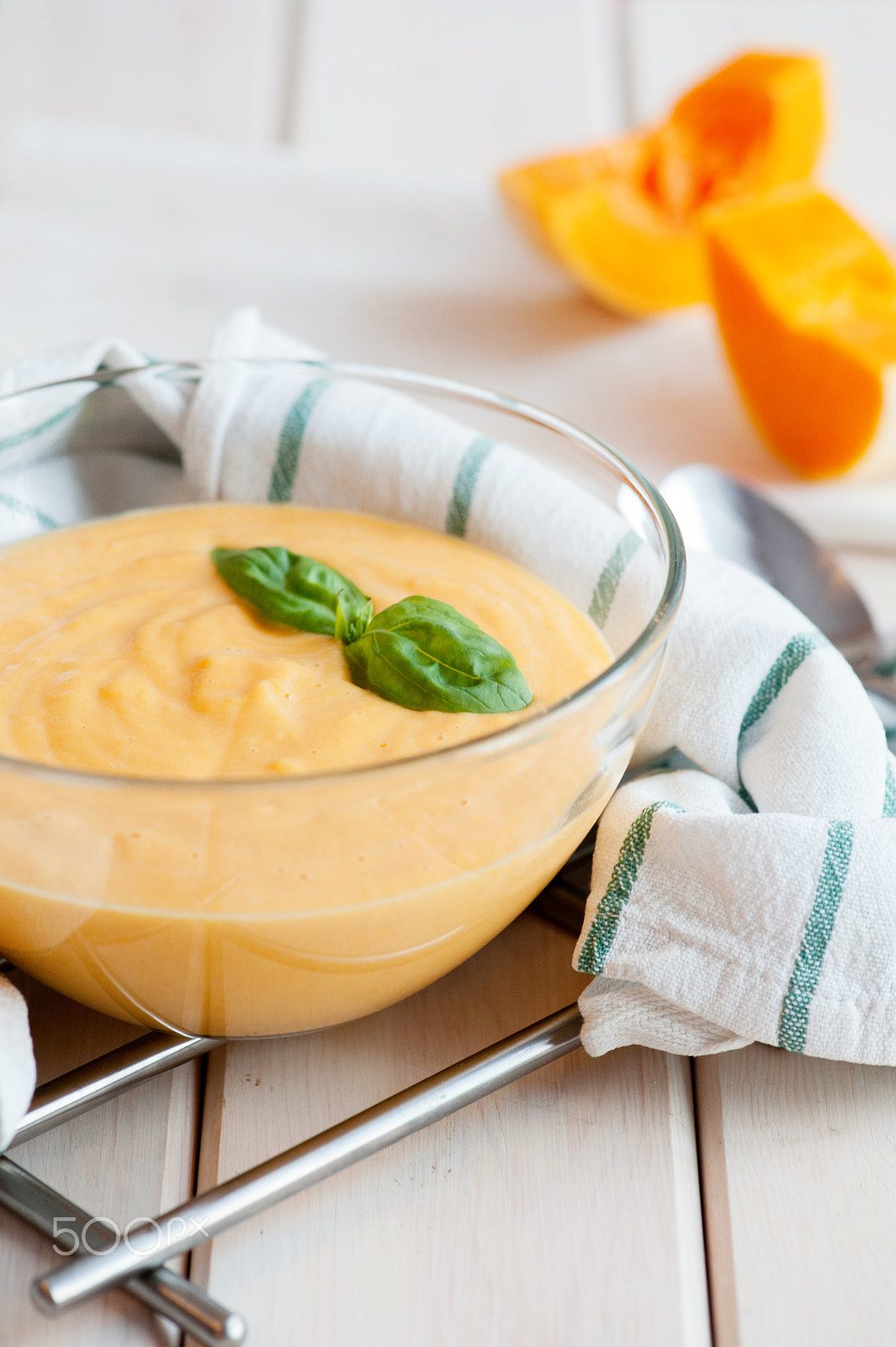 Nikon D700 sample photo. Pumpkin cream soup with basil and pumpkin slice on wooden background photography