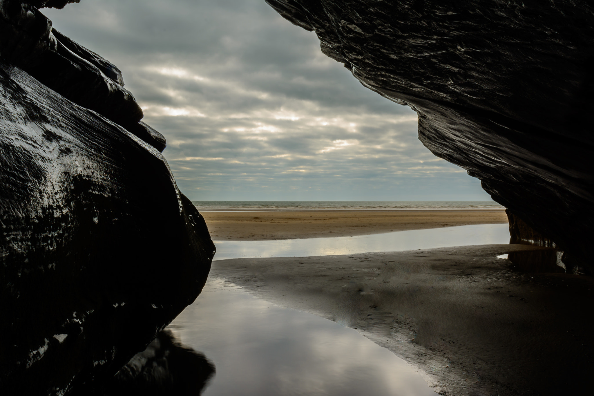 Nikon AF-S Nikkor 24-70mm F2.8G ED sample photo. Cave we found at black rock sands snowdonia photography