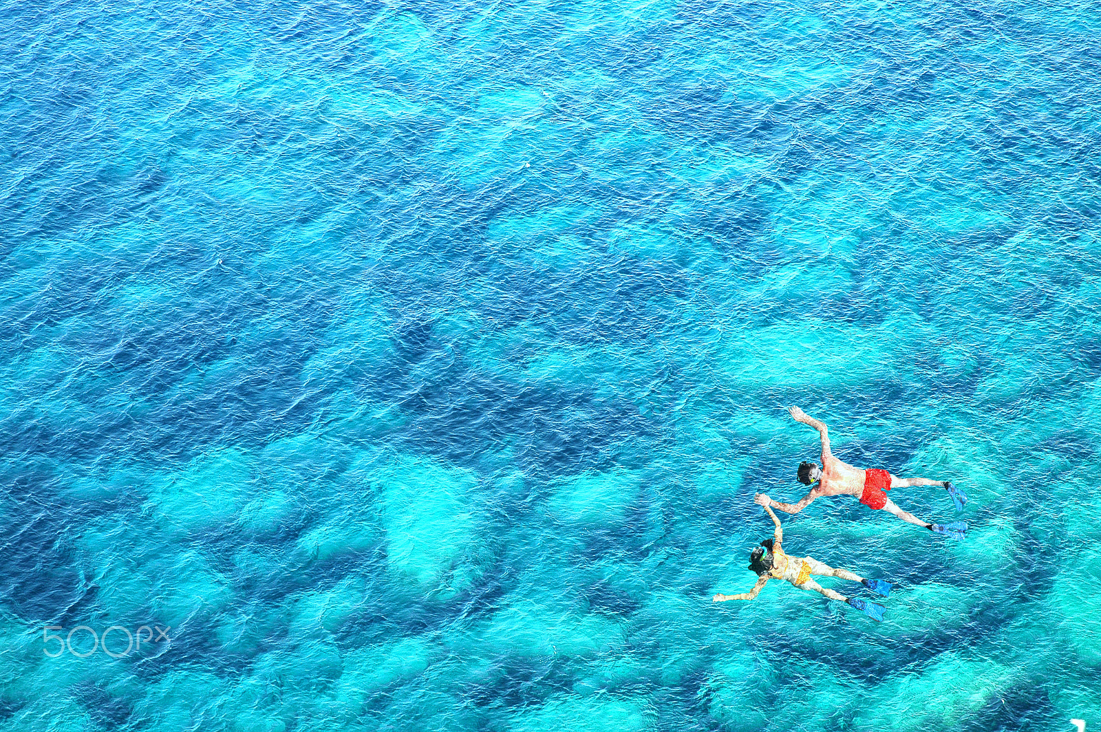 Nikon D70 sample photo. Above view of couple snorkeling in blue sea water photography