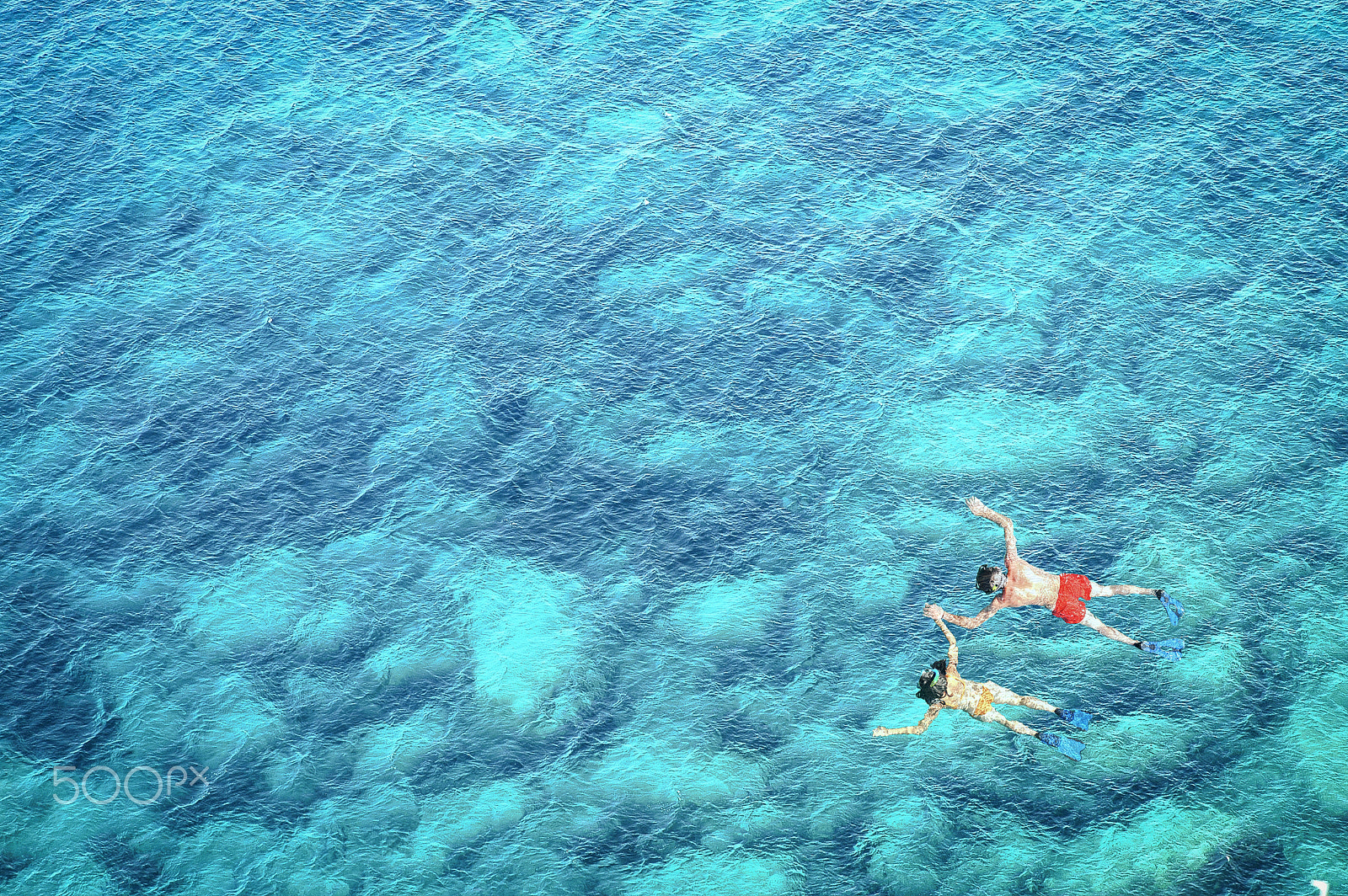 Nikon D70 sample photo. Above view of couple snorkeling in blue sea water photography