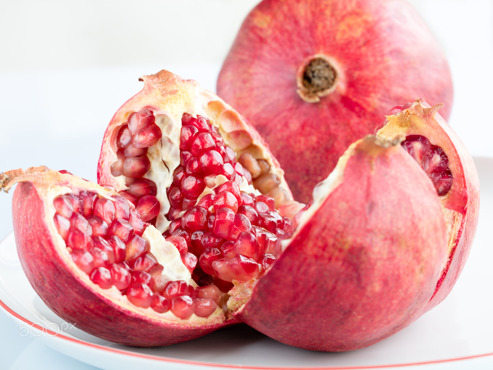 Canon EF 100mm F2.8L Macro IS USM sample photo. Ripe pomegranate fruit on a white porcelain plate photography