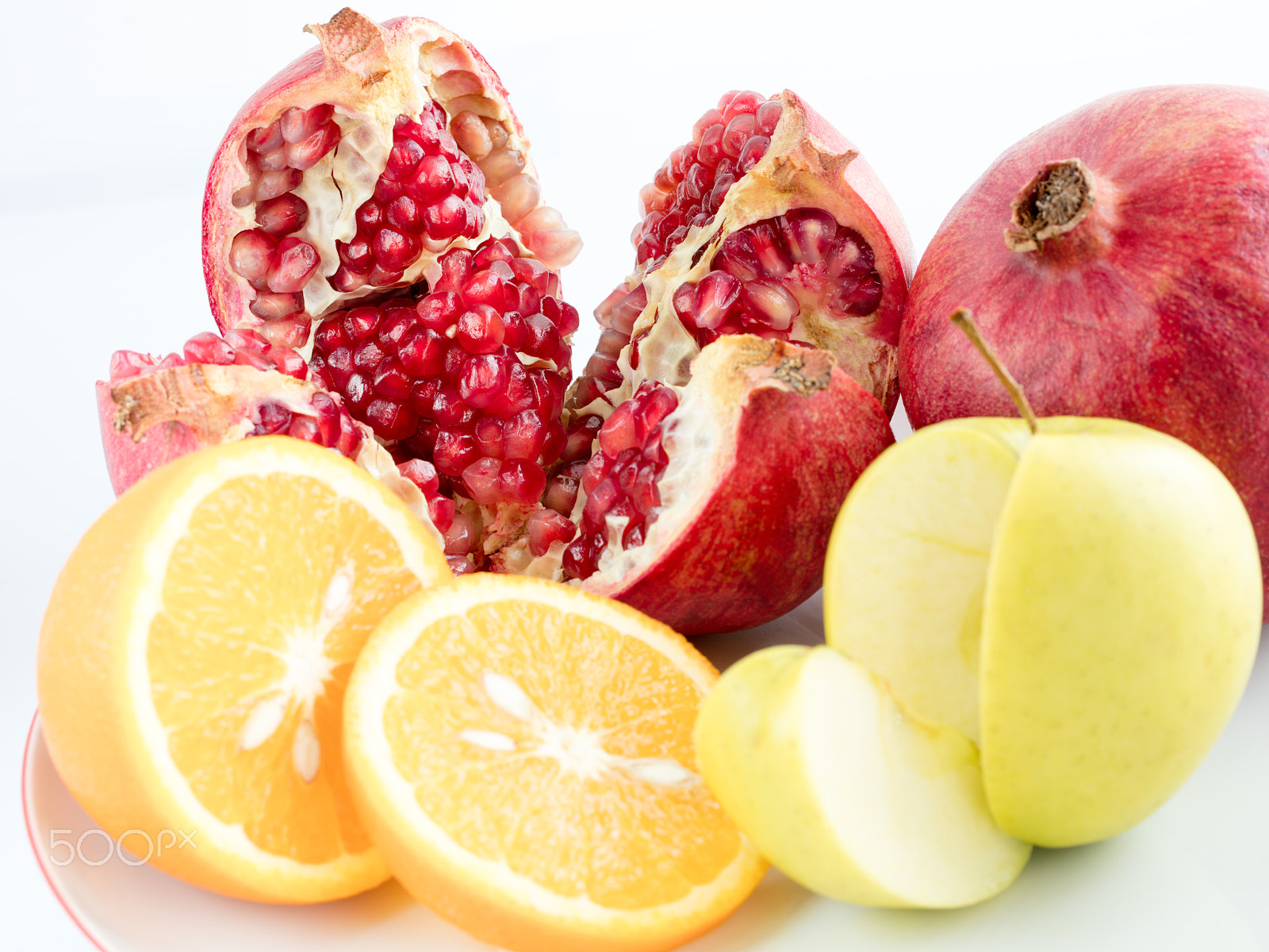 Canon EF 100mm F2.8L Macro IS USM sample photo. Orange, apple, pomegranate on an white background. photography