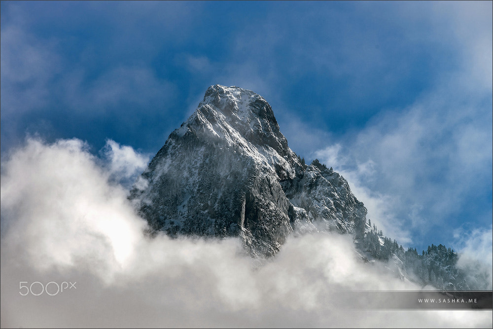Sony a99 II sample photo. Clouds around the peak of beautiful rock photography