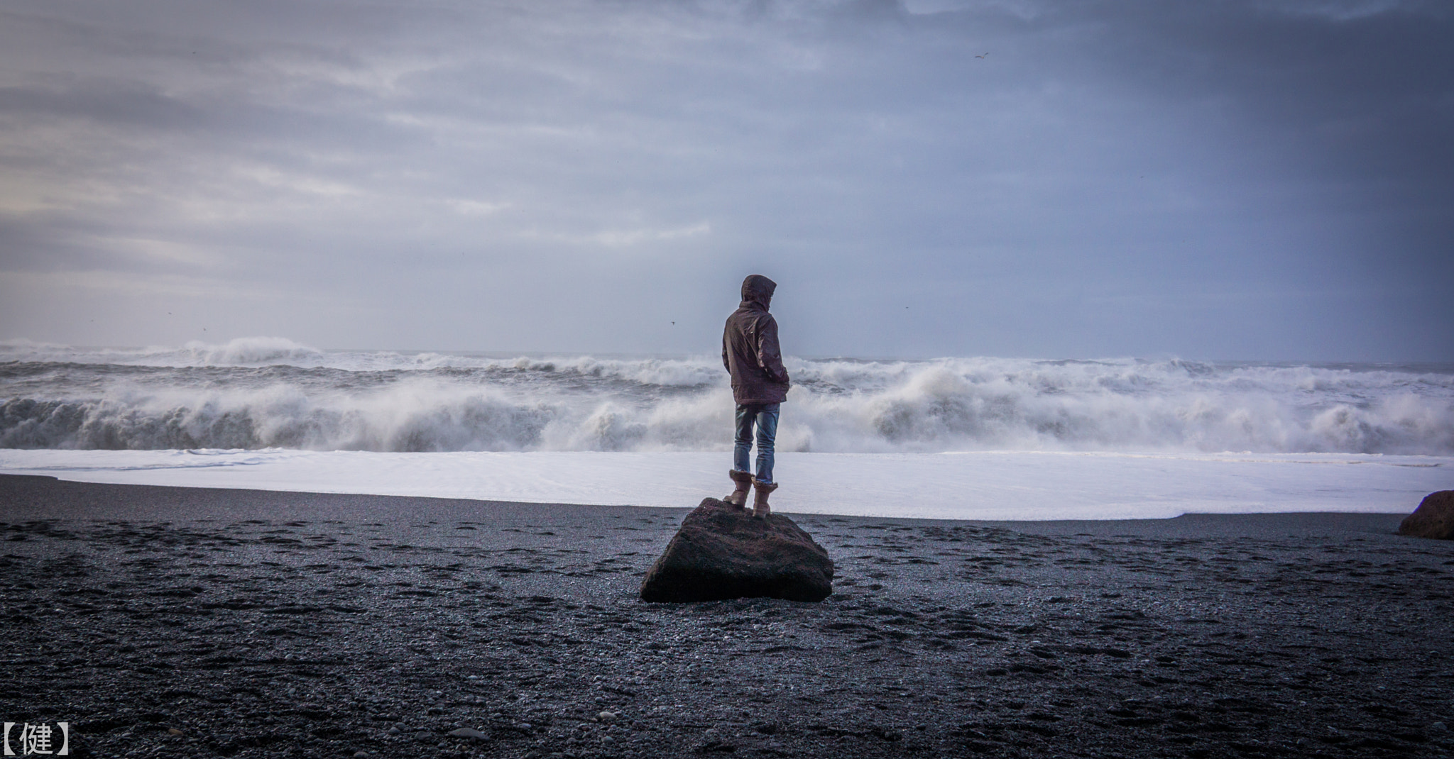 Sony E 18-200mm F3.5-6.3 OSS sample photo. Boy on a rock at black sand beach photography