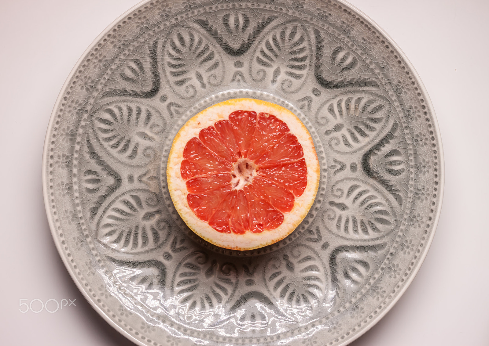 Canon EOS 500D (EOS Rebel T1i / EOS Kiss X3) + Canon EF 40mm F2.8 STM sample photo. Red grapefruit in grey plate photography