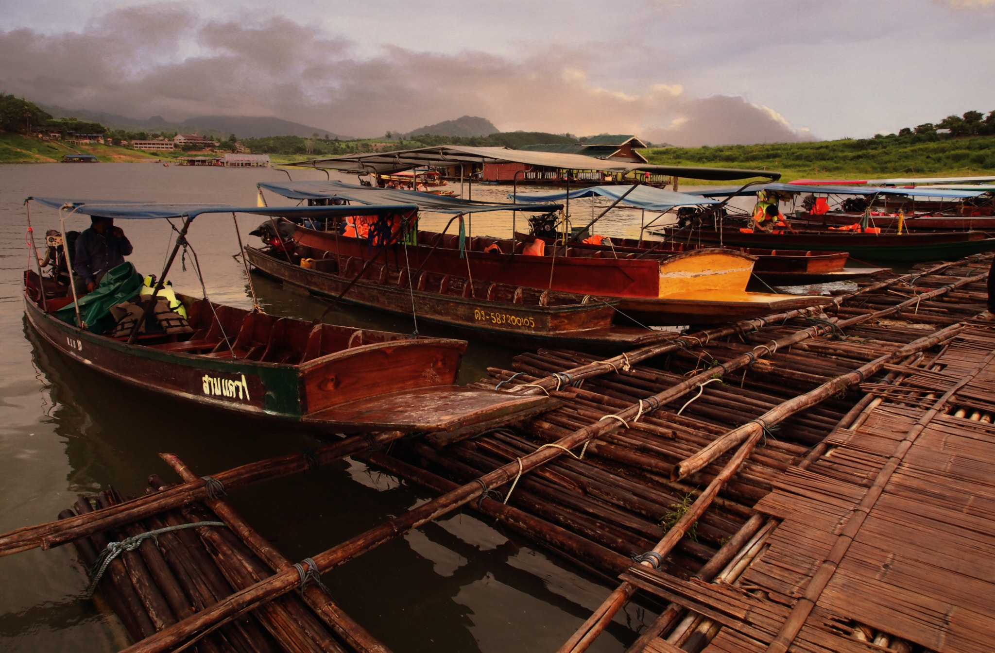 Olympus OM-D E-M5 sample photo. Wooden boats beside bamboo bridge photography