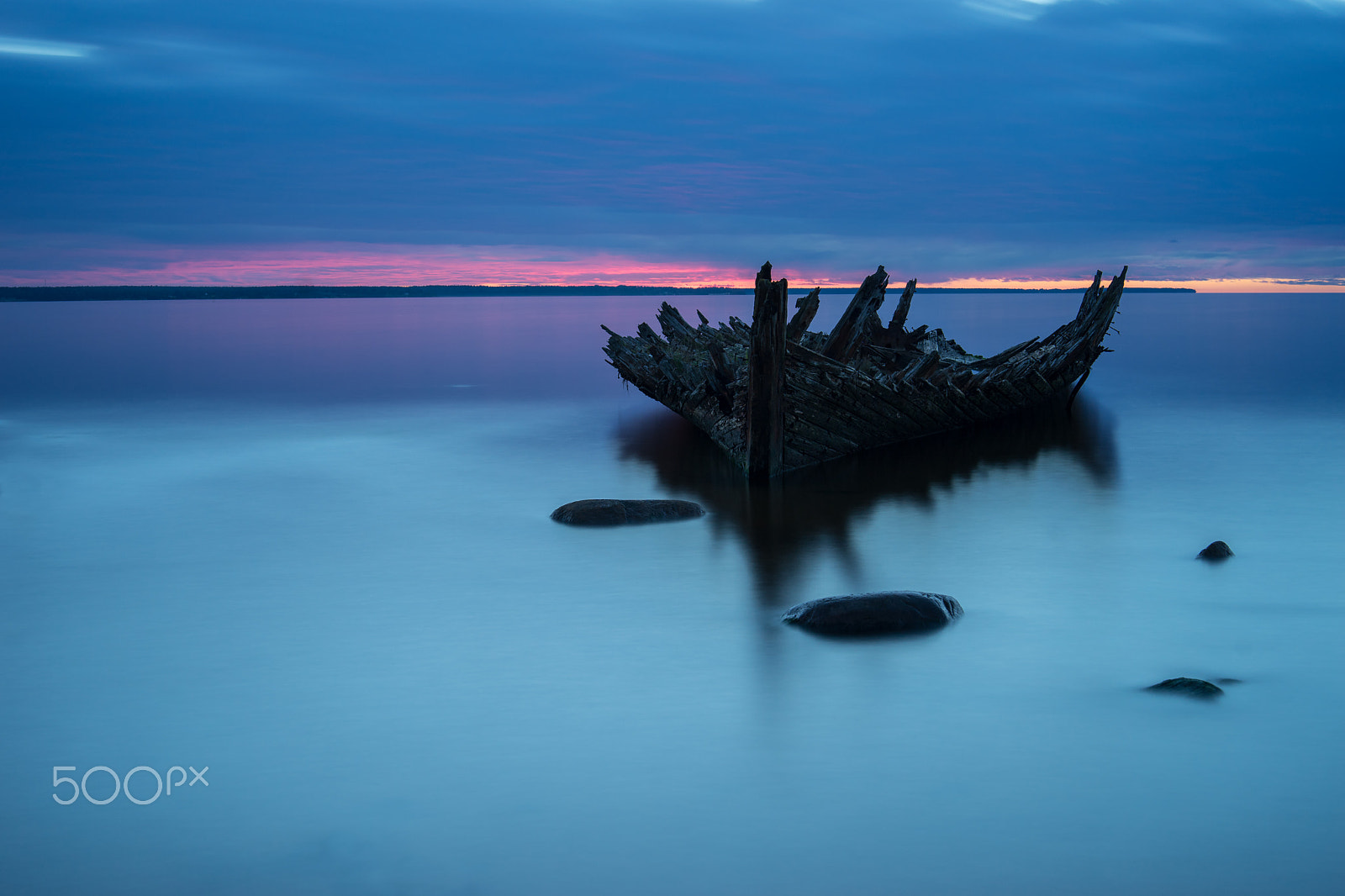 Sony a7 II + E 50mm F1.4 sample photo. Old broken boat wreck on the shore, a frozen sea and beautiful blue sunset background. estonia,... photography