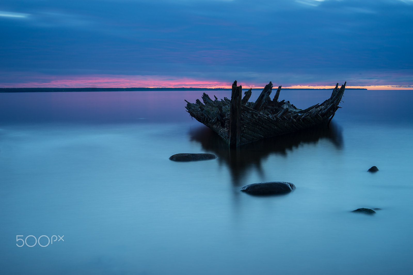 Sony a7 II + E 50mm F1.4 sample photo. Old broken boat wreck on the shore, a frozen sea and beautiful blue sunset background. estonia,... photography