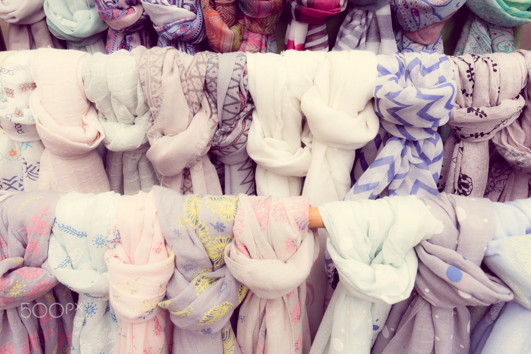 Different scarves tied with knots in market