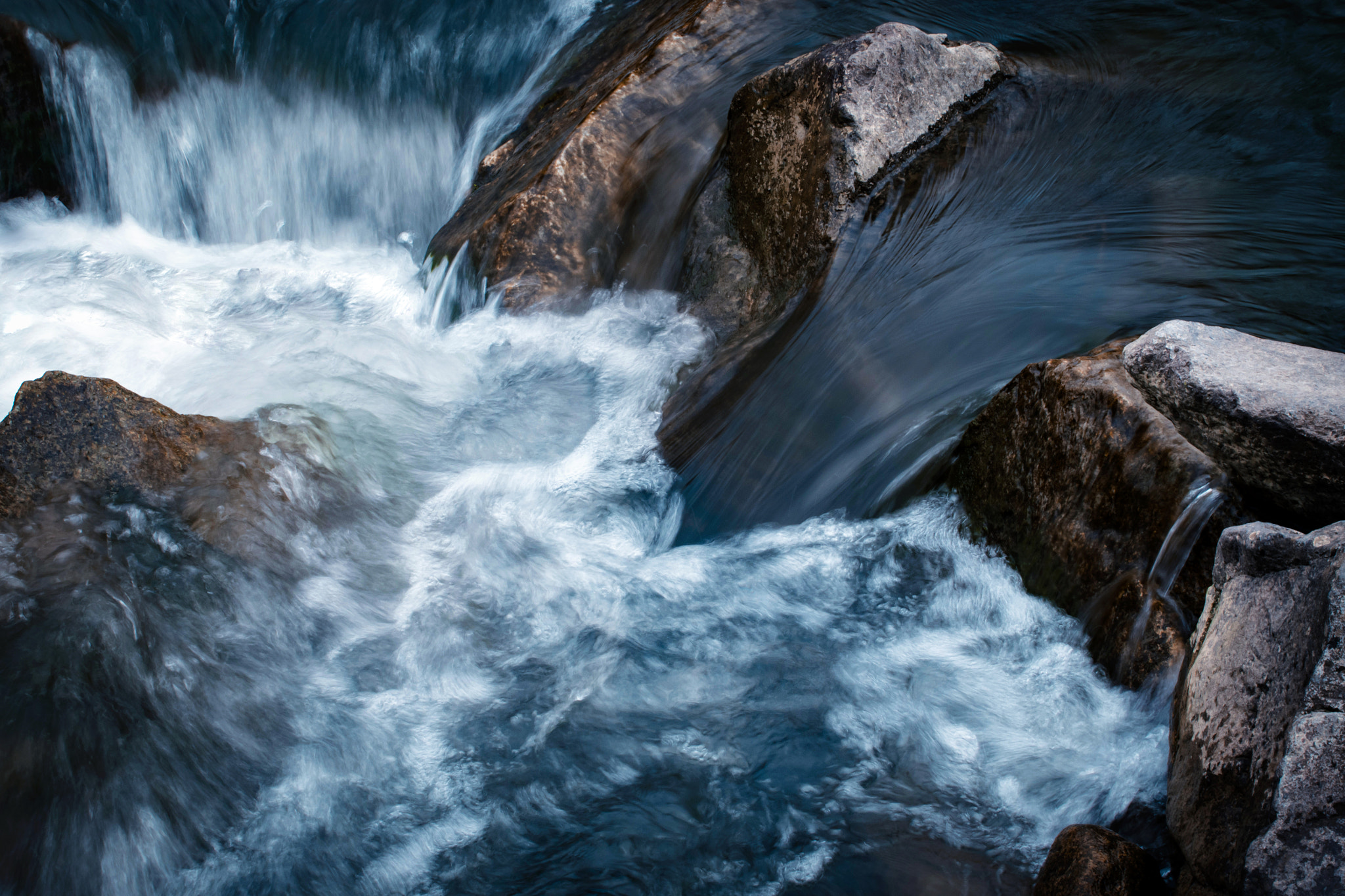 Nikon D5500 sample photo. Water flows between stones photography
