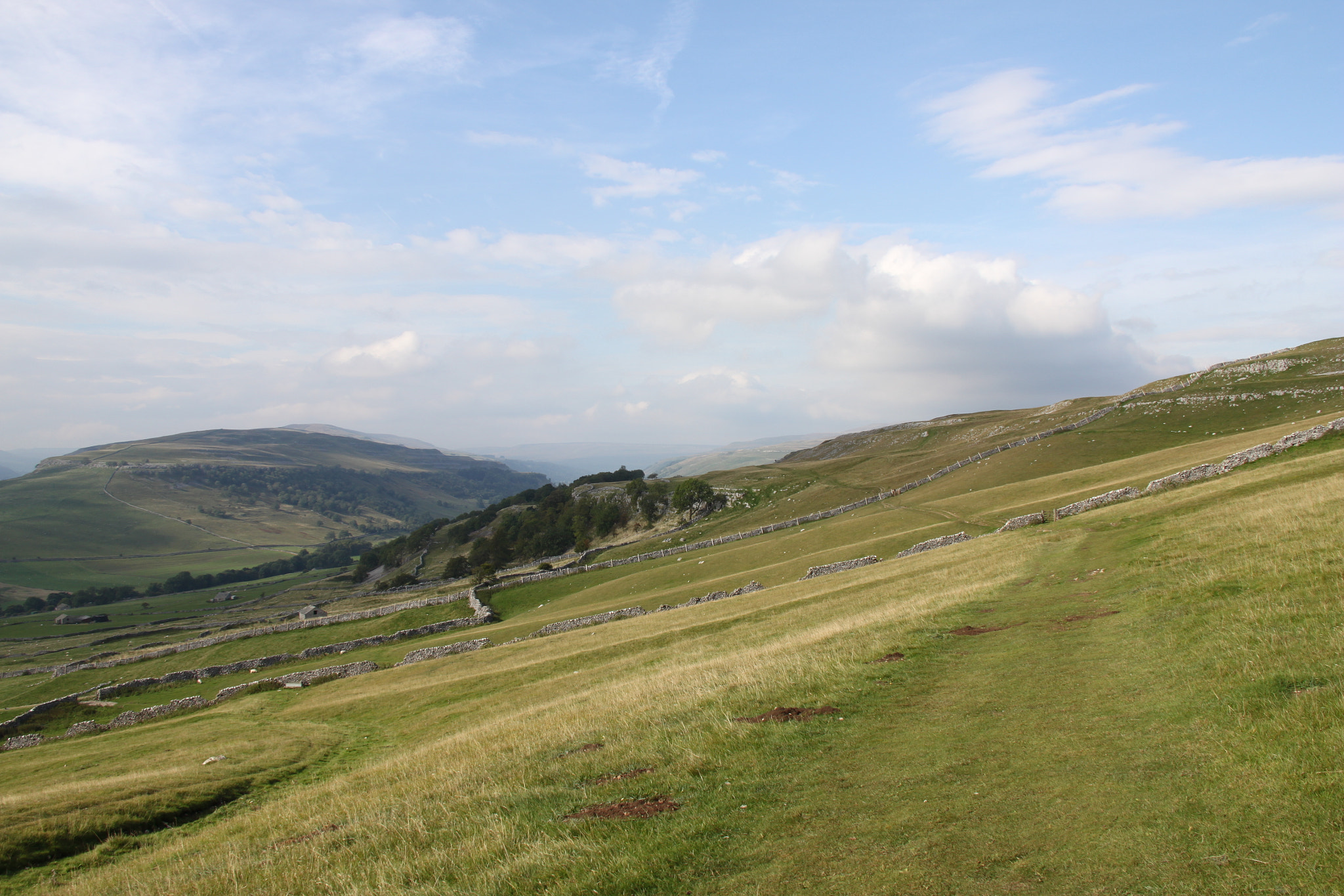Canon EF-S 18-200mm F3.5-5.6 IS sample photo. Stone walls on hills photography