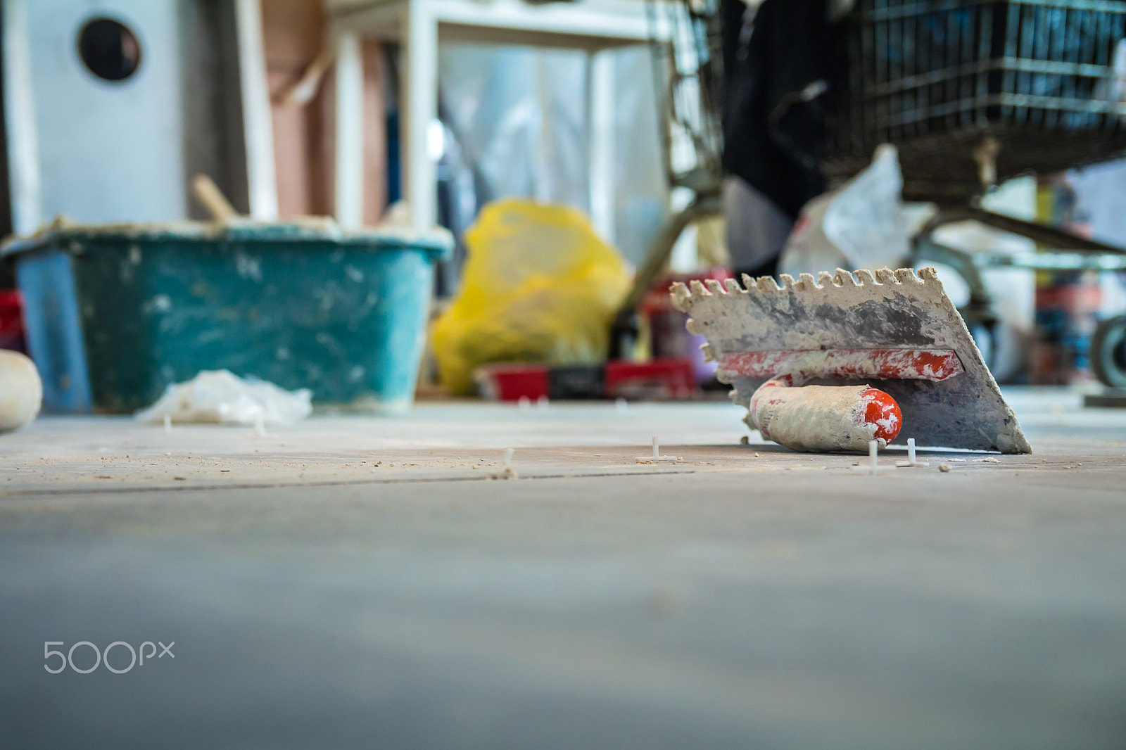 Canon EF-S 17-55mm F2.8 IS USM sample photo. Trowel on the floor in construction site photography