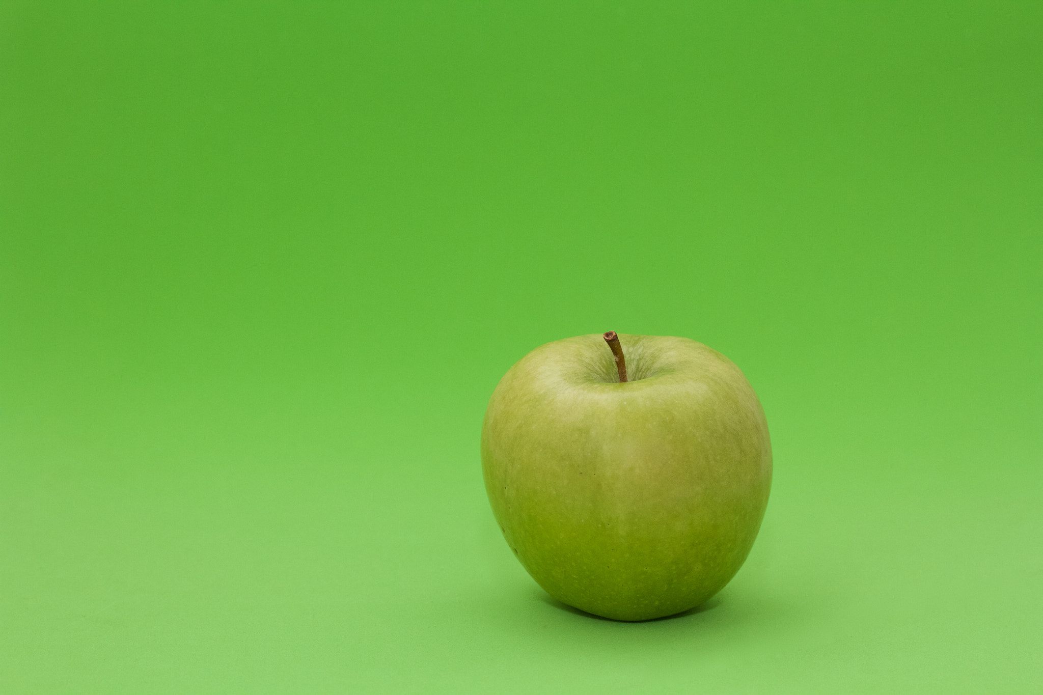 Canon EF-S 60mm F2.8 Macro USM sample photo. Apple on green background photography
