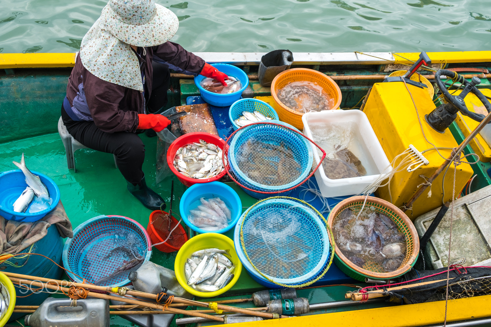 Fishman selling fish on boat