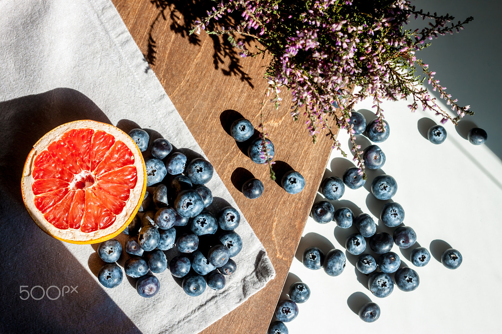 Canon EOS 500D (EOS Rebel T1i / EOS Kiss X3) + Canon EF 40mm F2.8 STM sample photo. Still life blueberries grapefruit and flower photography