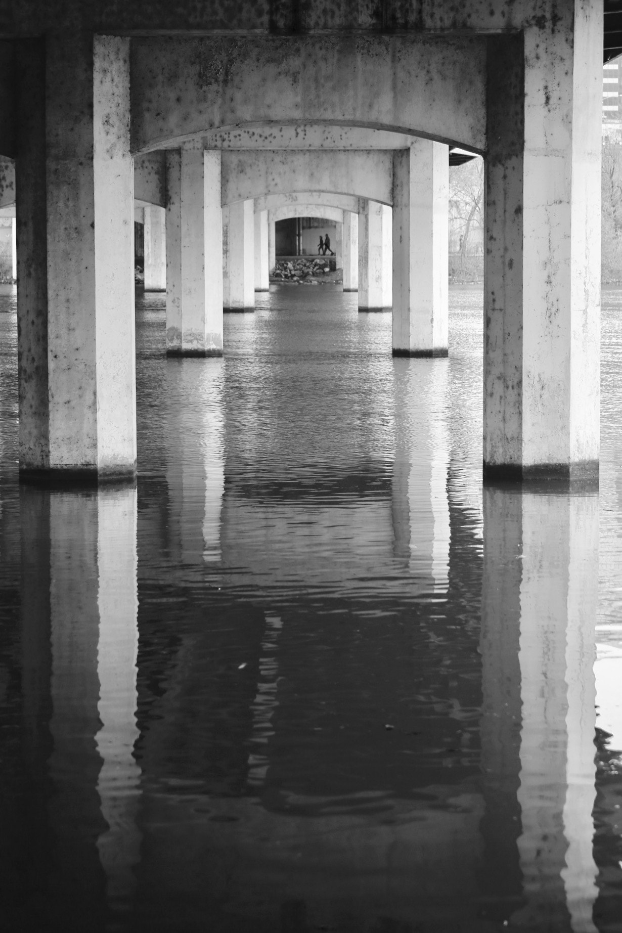Canon EF 70-300mm F4-5.6 IS USM sample photo. 2 people walking on a path under a bridge. photography