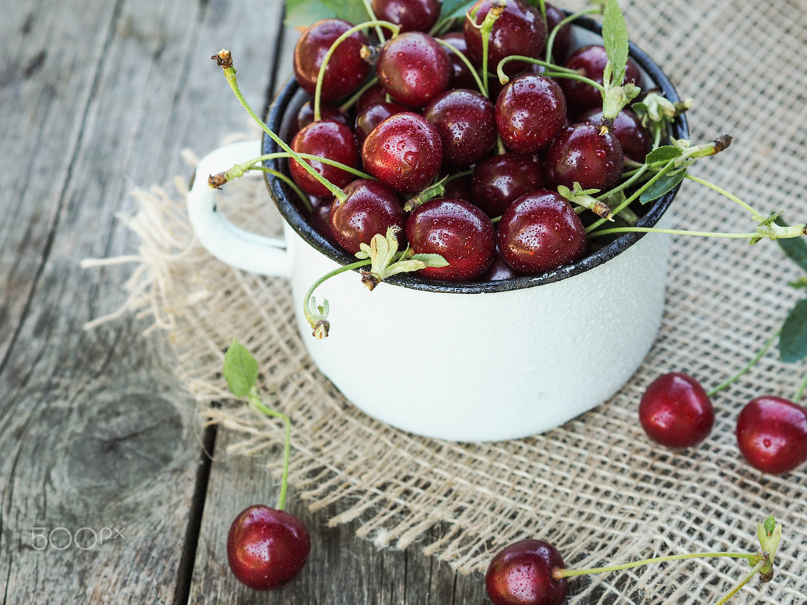 Olympus OM-D E-M10 sample photo. Ripe cherry with drops of water in cup photography