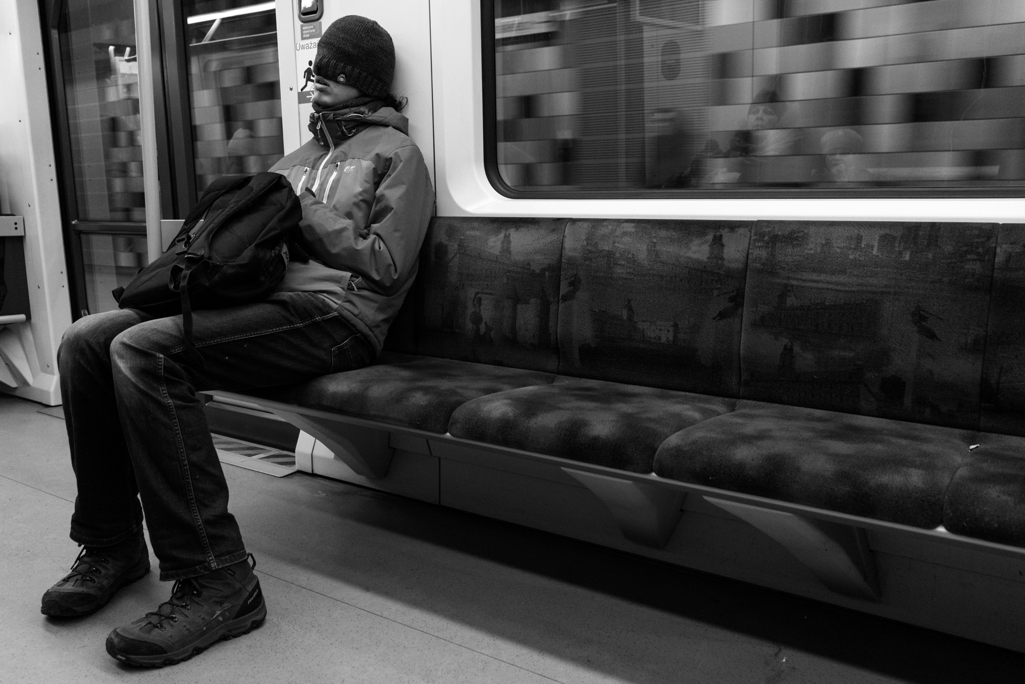 Sony FE 28mm F2 sample photo. A sleeping man in the metro photography
