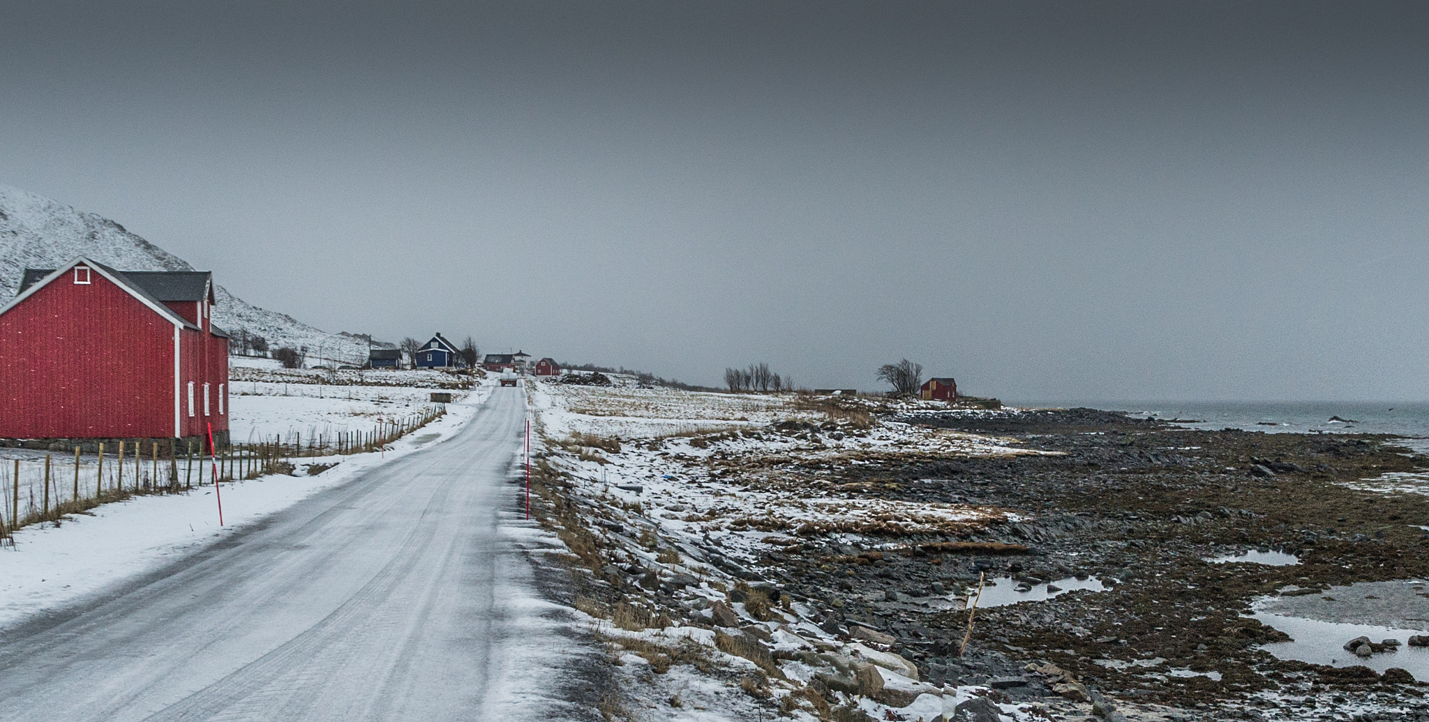 Nikon D3S + Sigma 17-70mm F2.8-4 DC Macro OS HSM sample photo. Icy gravelroad along the shore /lofoten photography