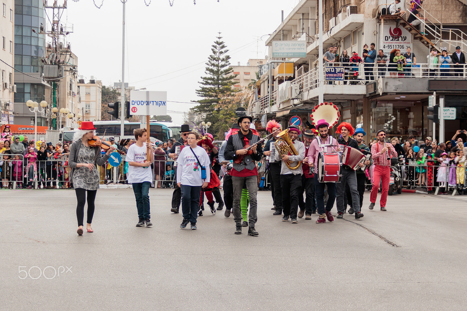 Canon EF 75-300mm F4.0-5.6 IS USM sample photo. Participantin in carnival walking near viewers and playing music photography