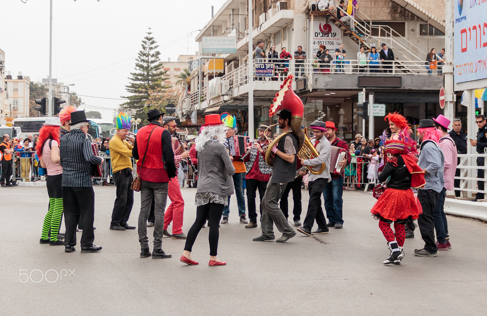Canon EF 75-300mm F4.0-5.6 IS USM sample photo. Participantin in carnival walking near viewers and playing music photography