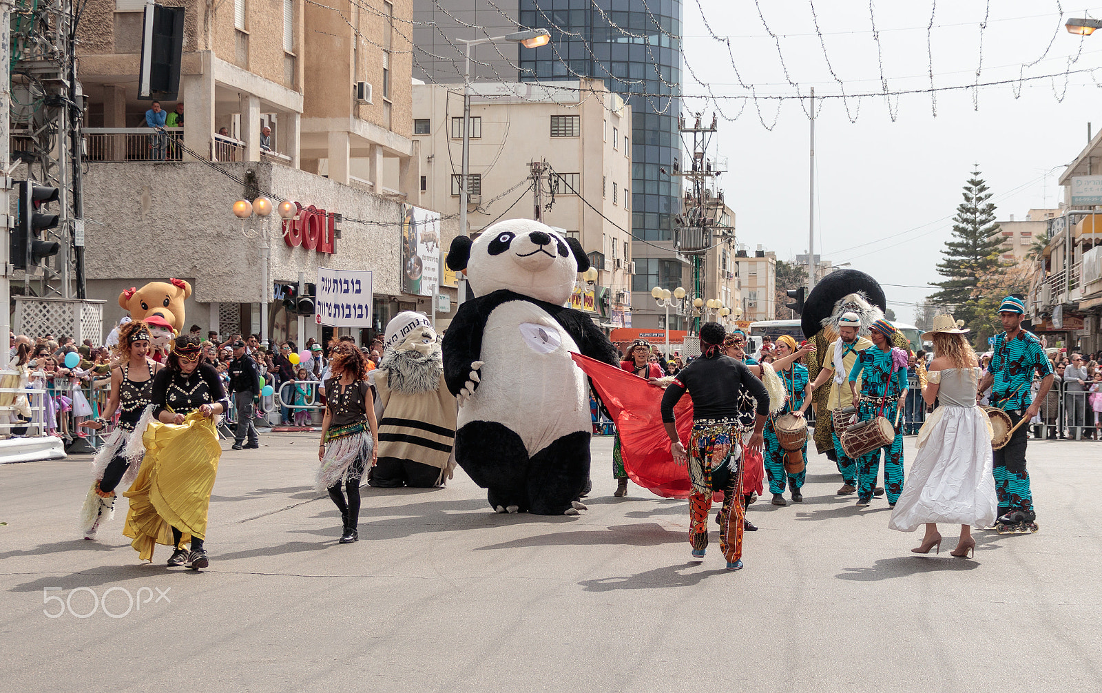Canon EF 75-300mm F4.0-5.6 IS USM sample photo. Participants at the carnival parade dancing near the viewers photography