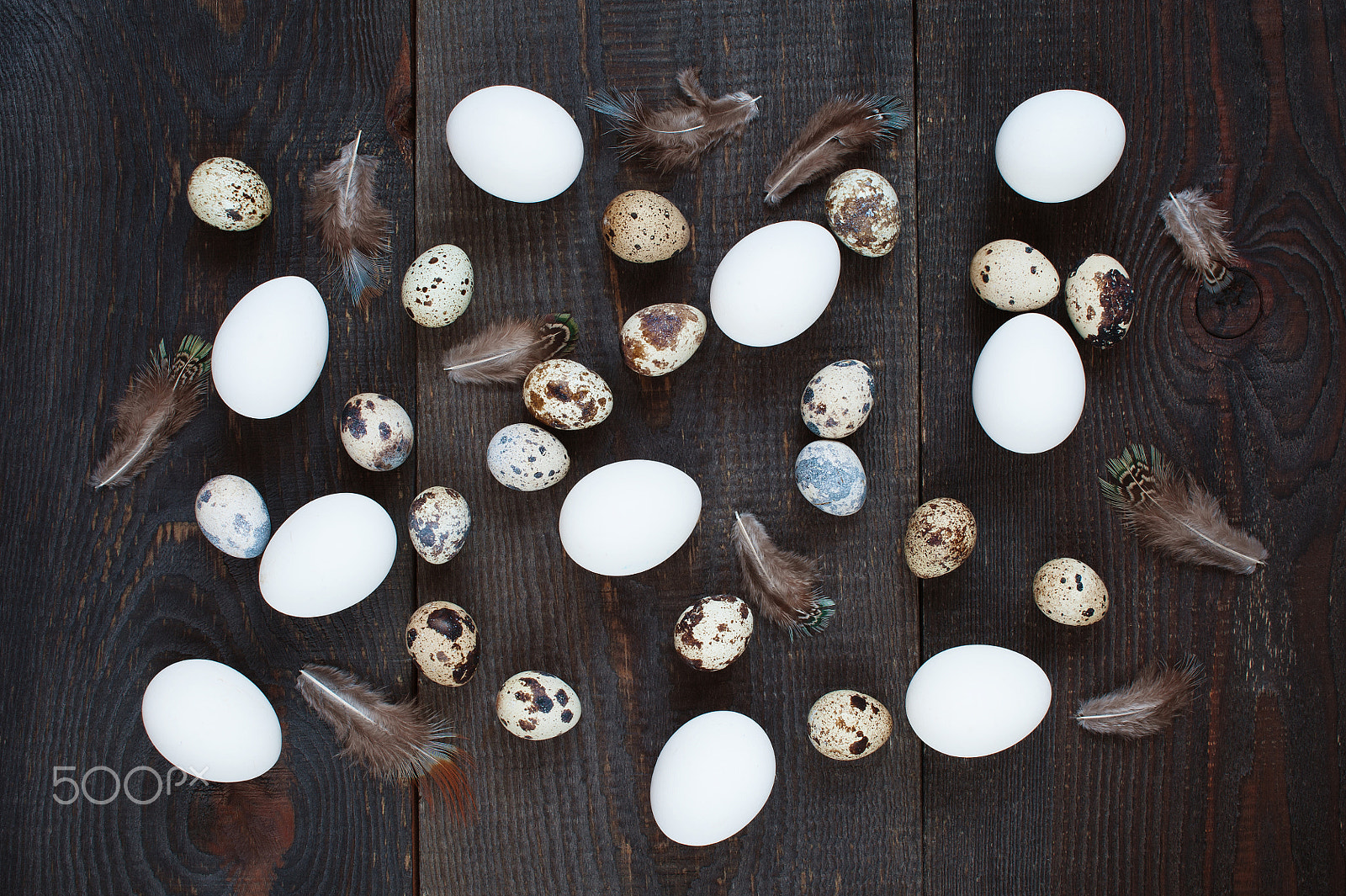 Nikon D700 sample photo. Chicken and quail eggs scattered on the brown wooden table photography