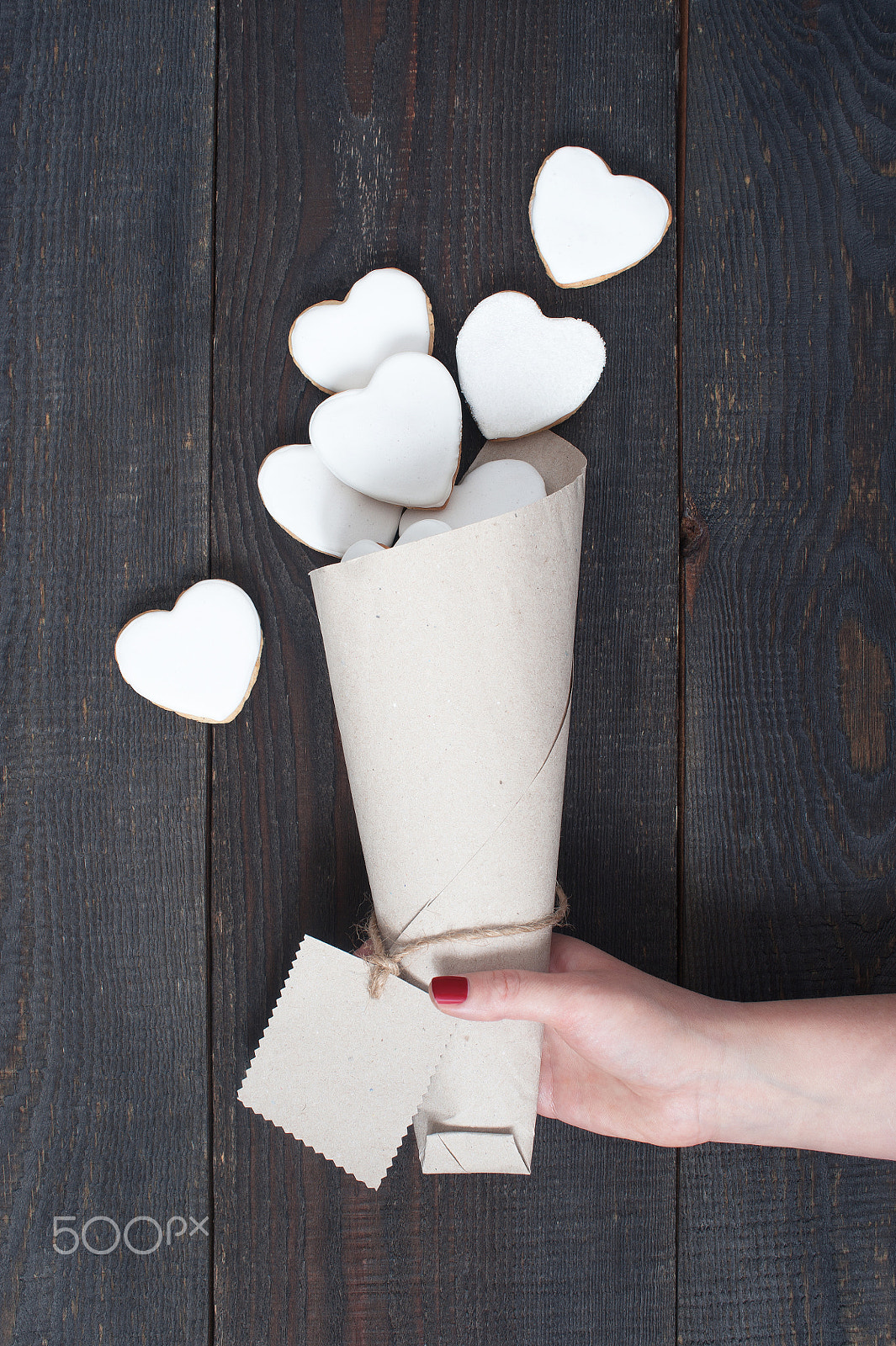 Nikon D700 sample photo. Female hand holding the pocket with white cookies-hearts photography