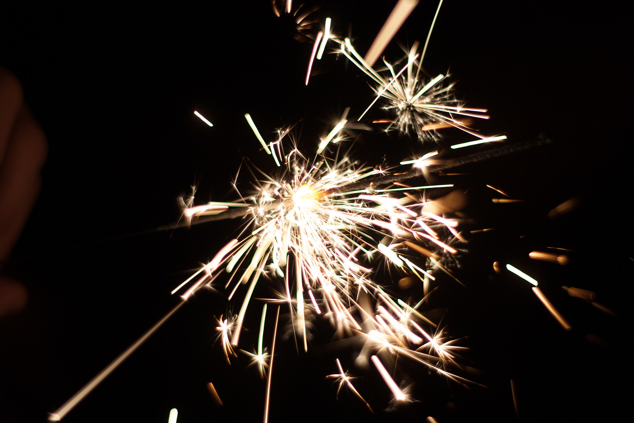 Canon EOS 30D + Canon EF 50mm f/1.8 sample photo. A lit sparkler in darkness photography