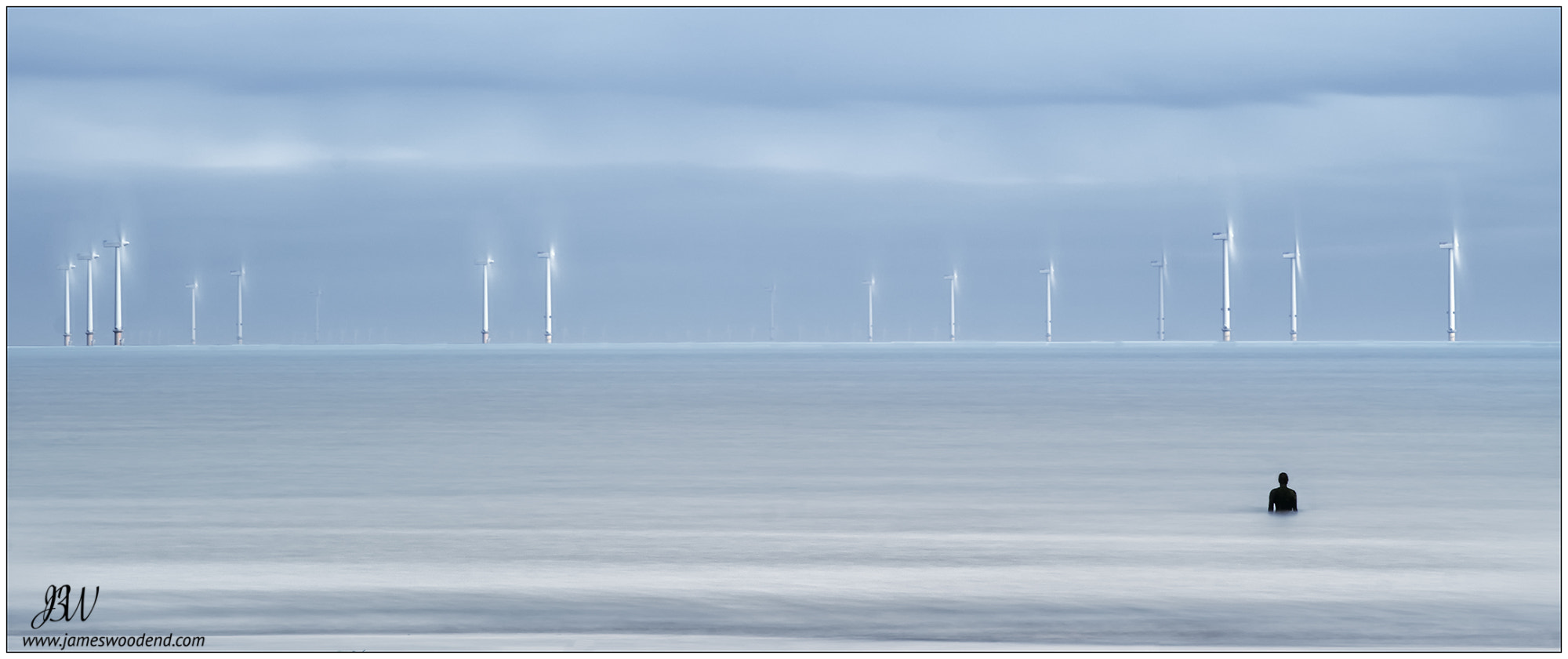 Sony a7R II sample photo. Half covered gormley statue, crosby beach photography