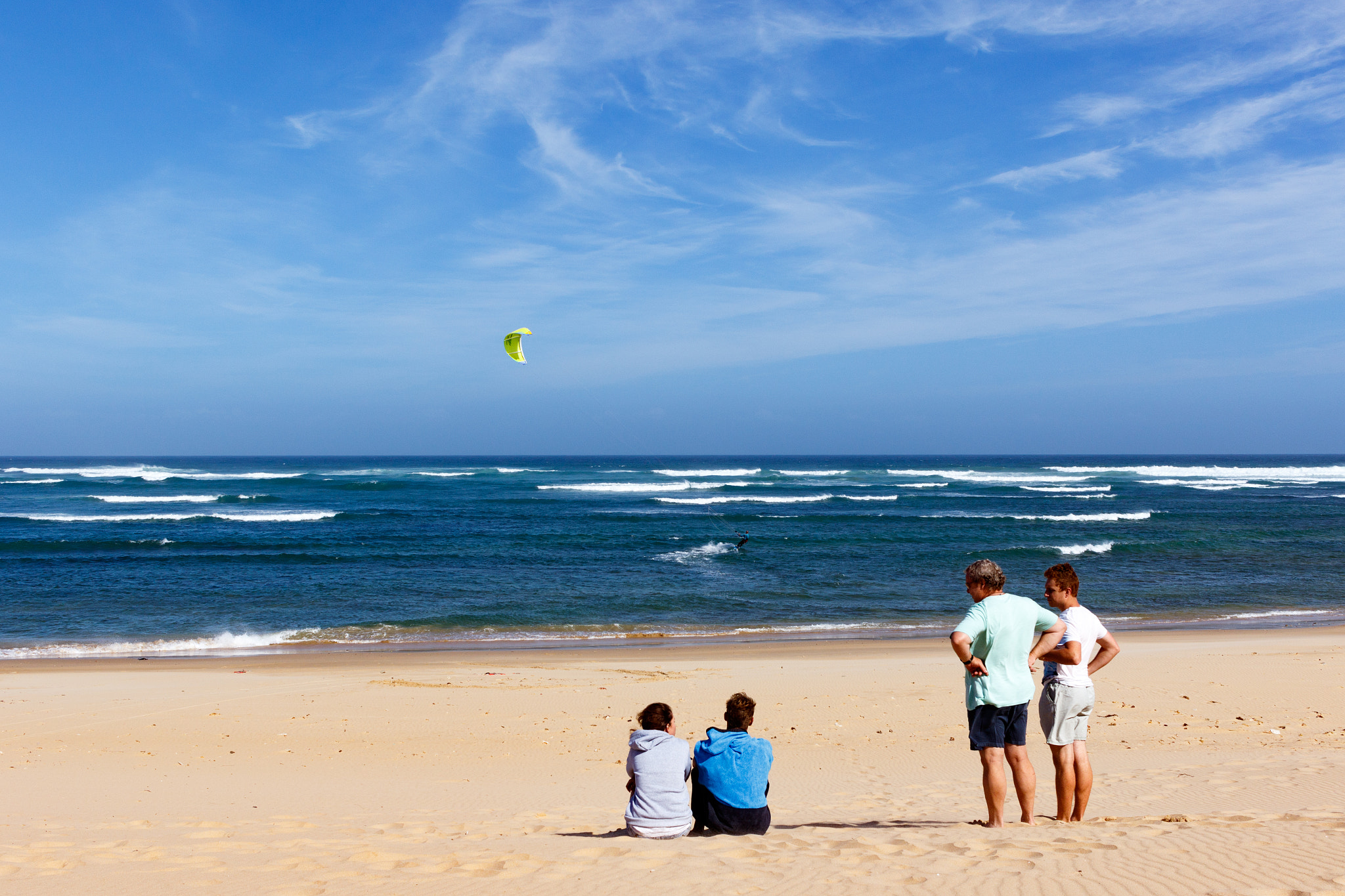Canon EF-S 24mm F2.8 STM sample photo. Group of people watching the kitesurfing photography