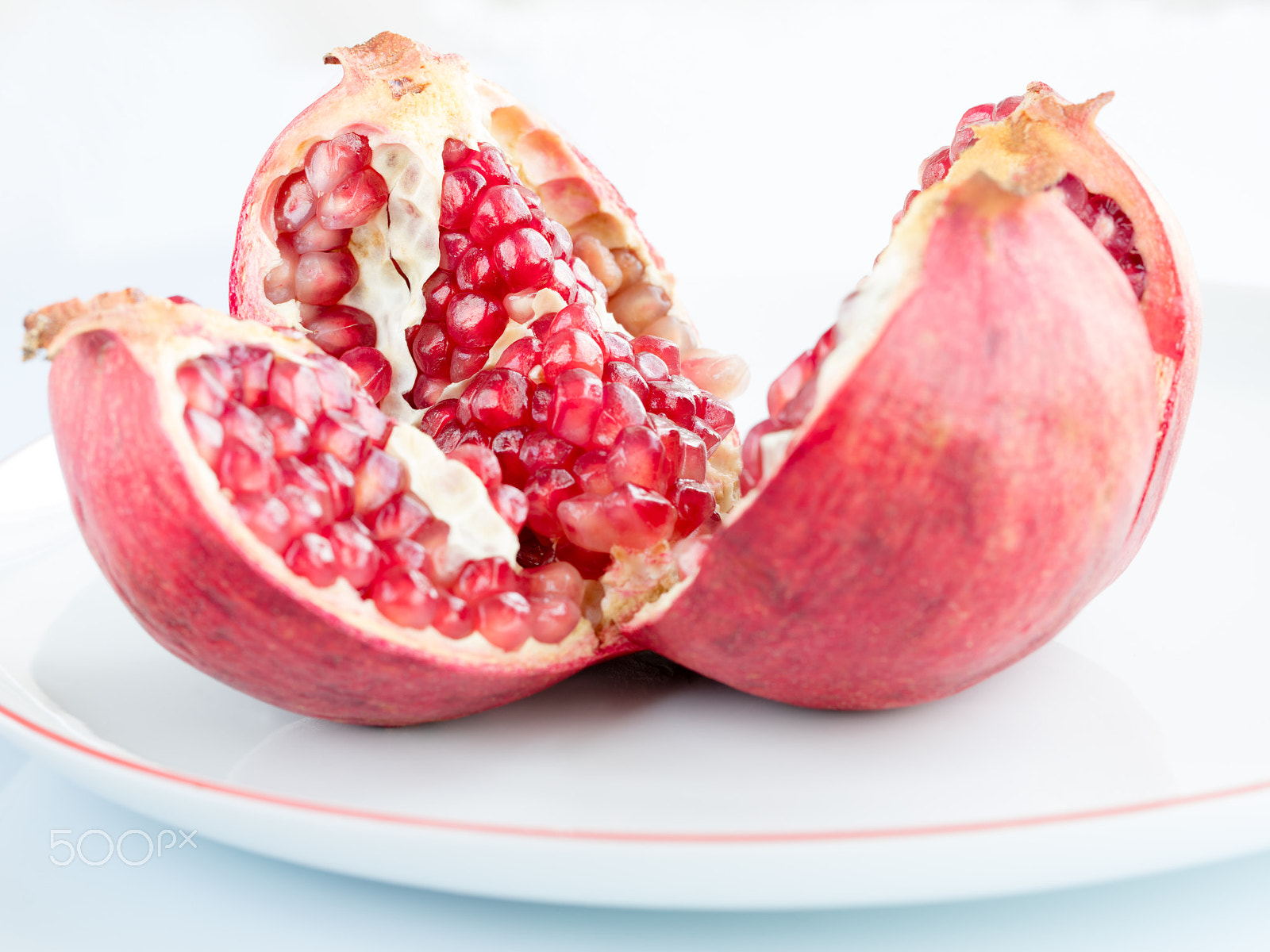 Canon EOS 5DS R sample photo. Ripe pomegranate fruit on a white porcelain plate photography