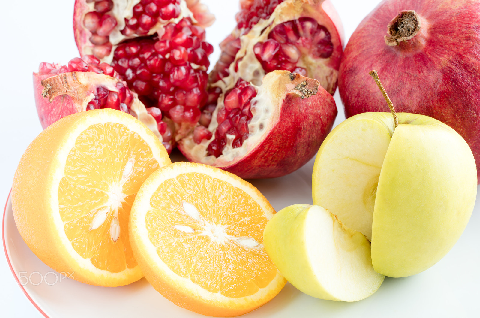 Canon EF 100mm F2.8L Macro IS USM sample photo. Orange, apple, pomegranate on an white background. photography