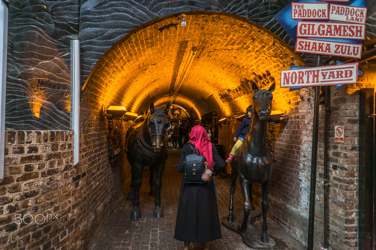 Sony a6000 + Sony E 16mm F2.8 sample photo. Little girl playing on horse statue photography