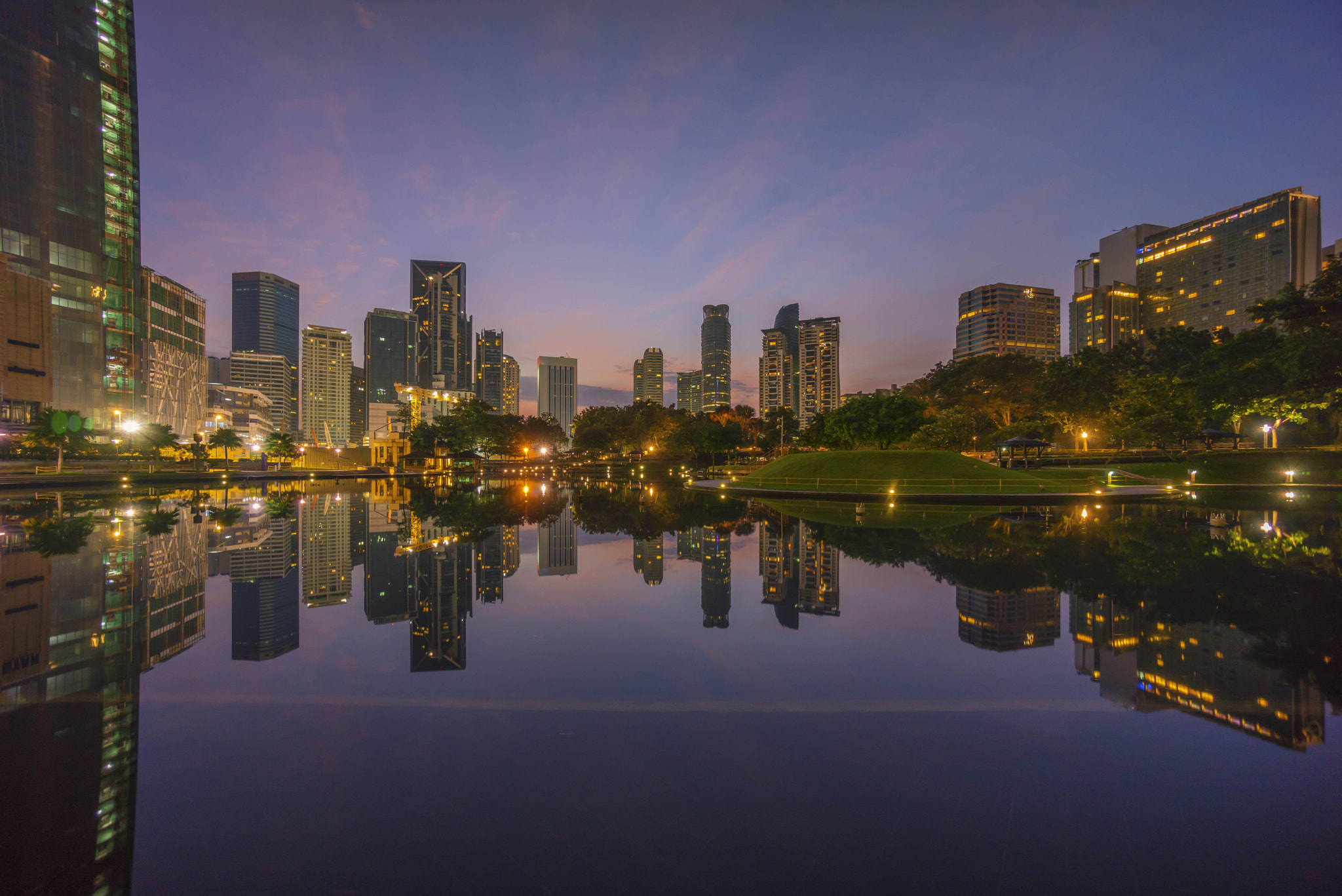 Sony a7R + Sony E 10-18mm F4 OSS sample photo. Sunrise blue hour at kuala lumpur city skyline with reflection photography