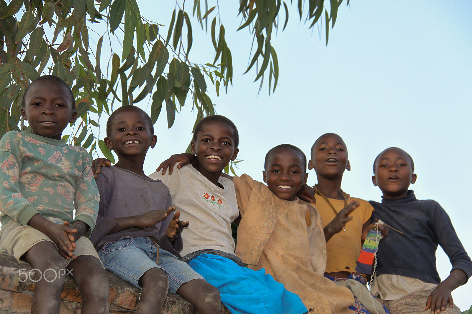 Canon EF-S 18-200mm F3.5-5.6 IS sample photo. Rwandan children sitting on a wall photography