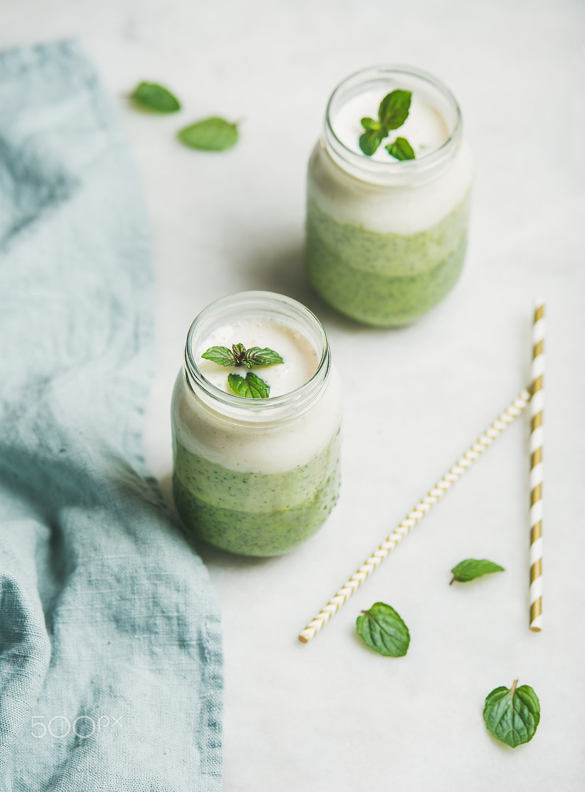 Nikon D610 + Nikon AF-S Nikkor 70-200mm F2.8G ED VR II sample photo. Ombre layered green smoothies with mint in glass jars photography