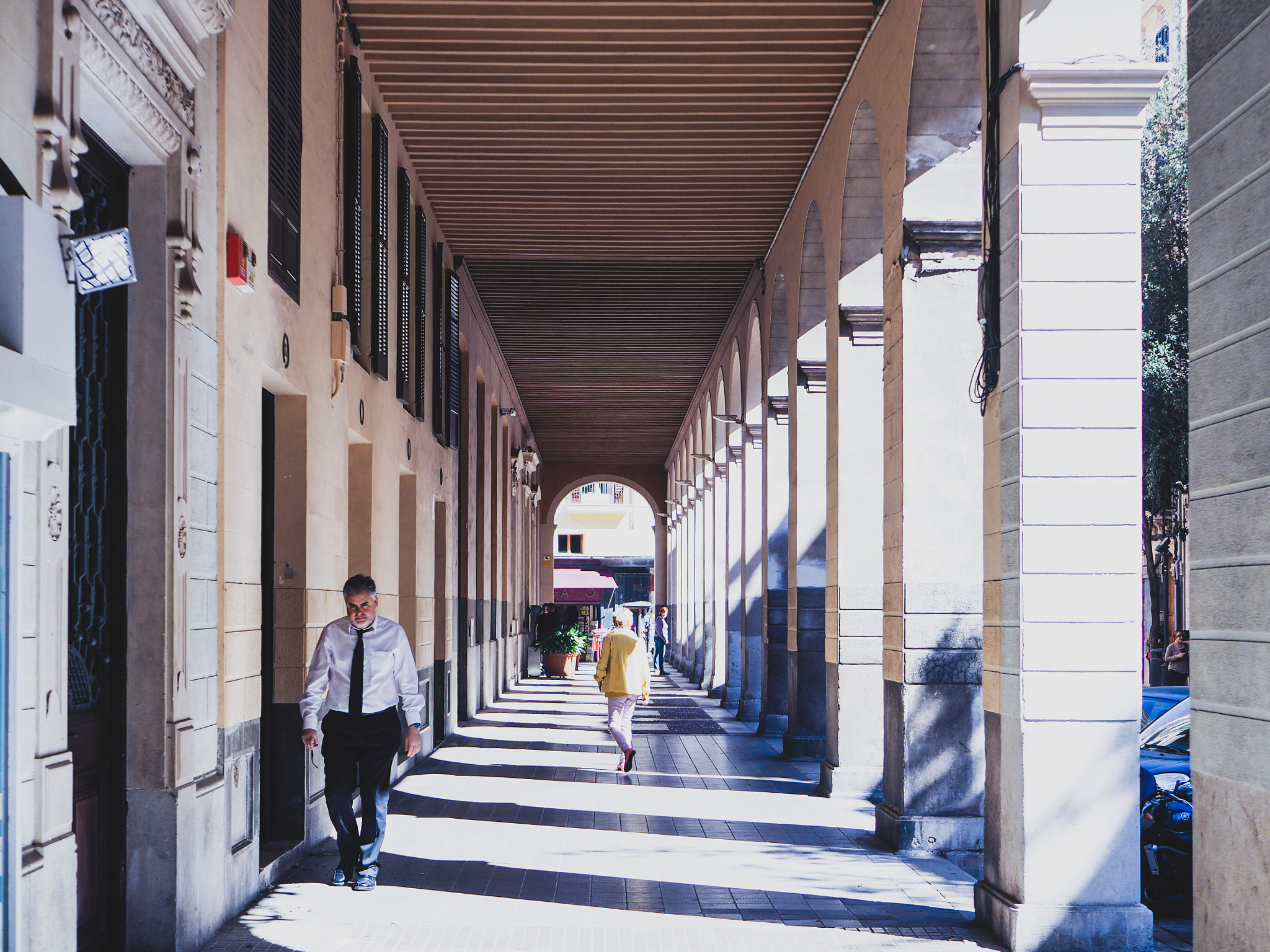 Olympus OM-D E-M10 II sample photo. Symmetry of poles in spain photography