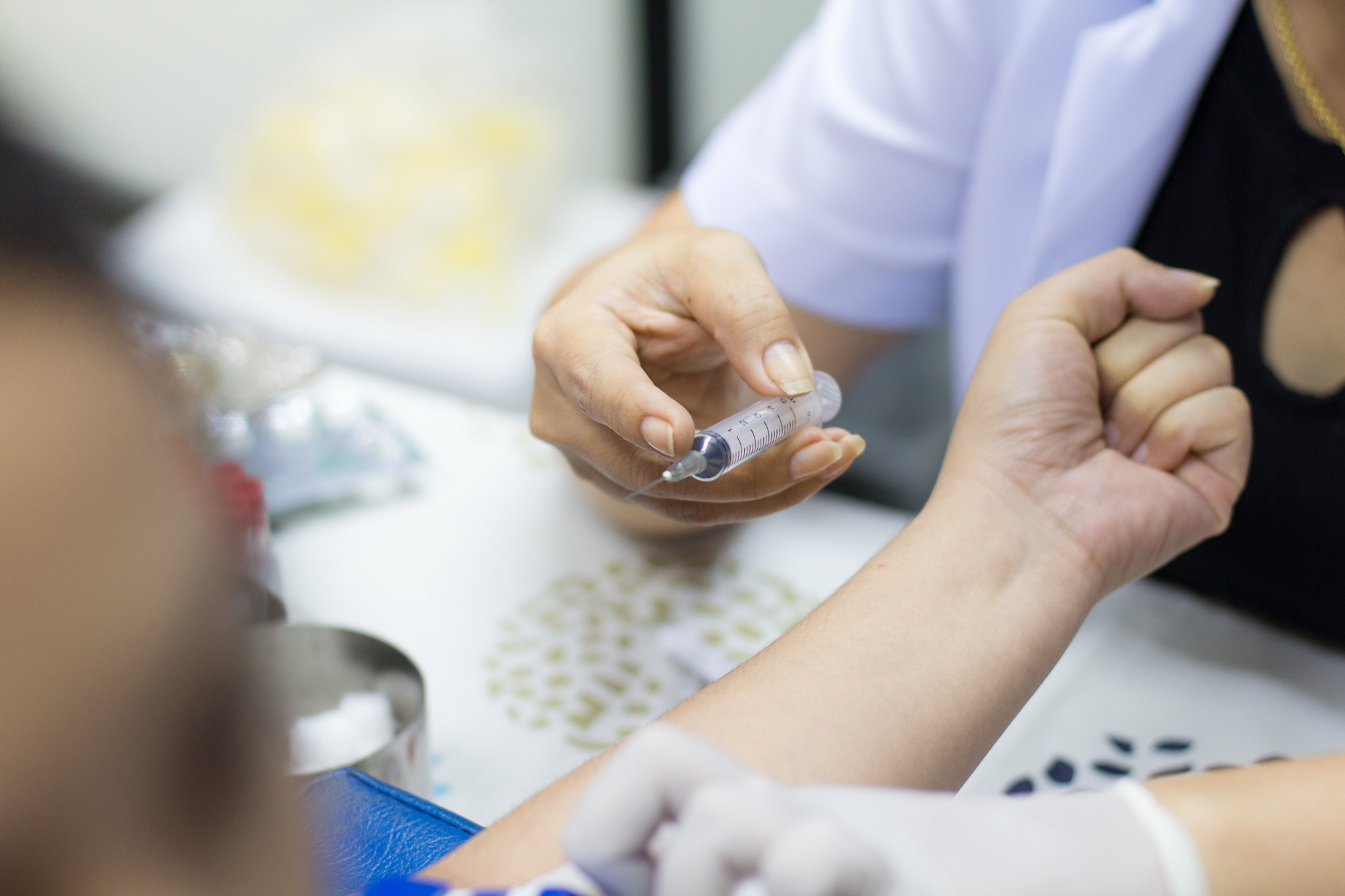 Canon EOS 60D + Canon EF 50mm F1.4 USM sample photo. Nurse collecting blood samples from patient for analysis on the photography