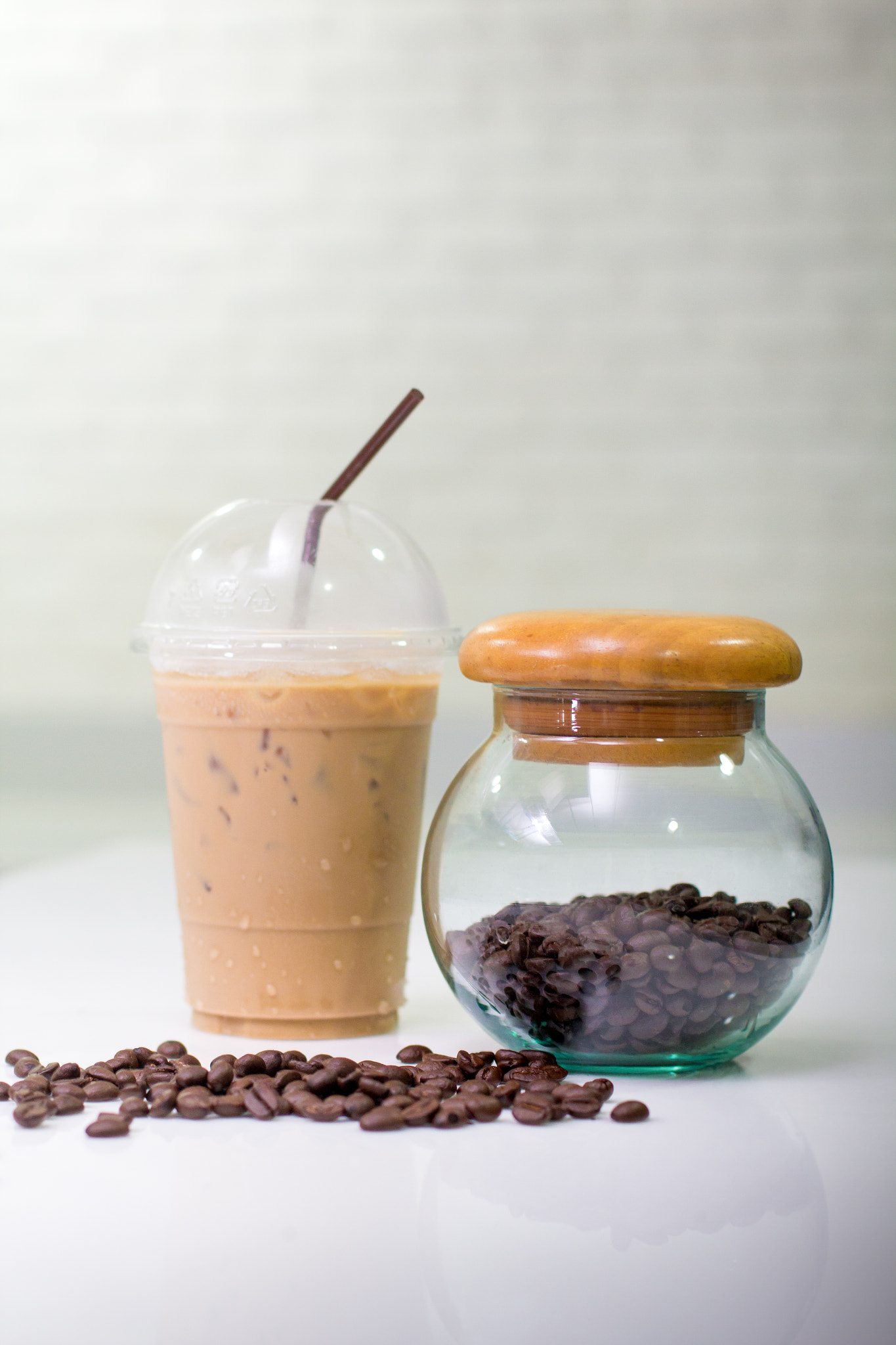 coffee beans with Coffee jar and Ice coffee on modern kitchen ta