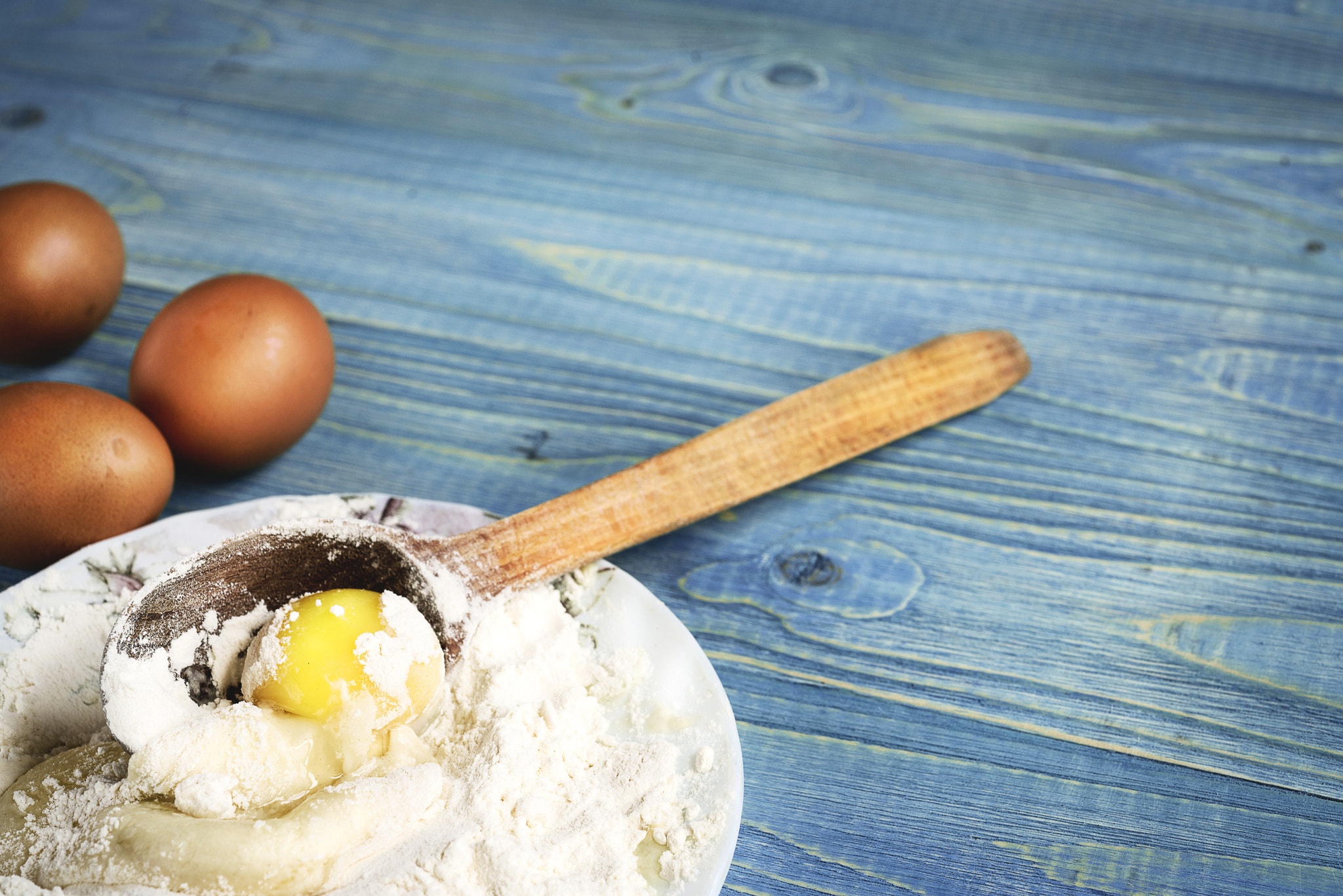 Nikon D750 + Nikon AF Micro-Nikkor 60mm F2.8D sample photo. Eggs and flour on a wooden background, baking back photography