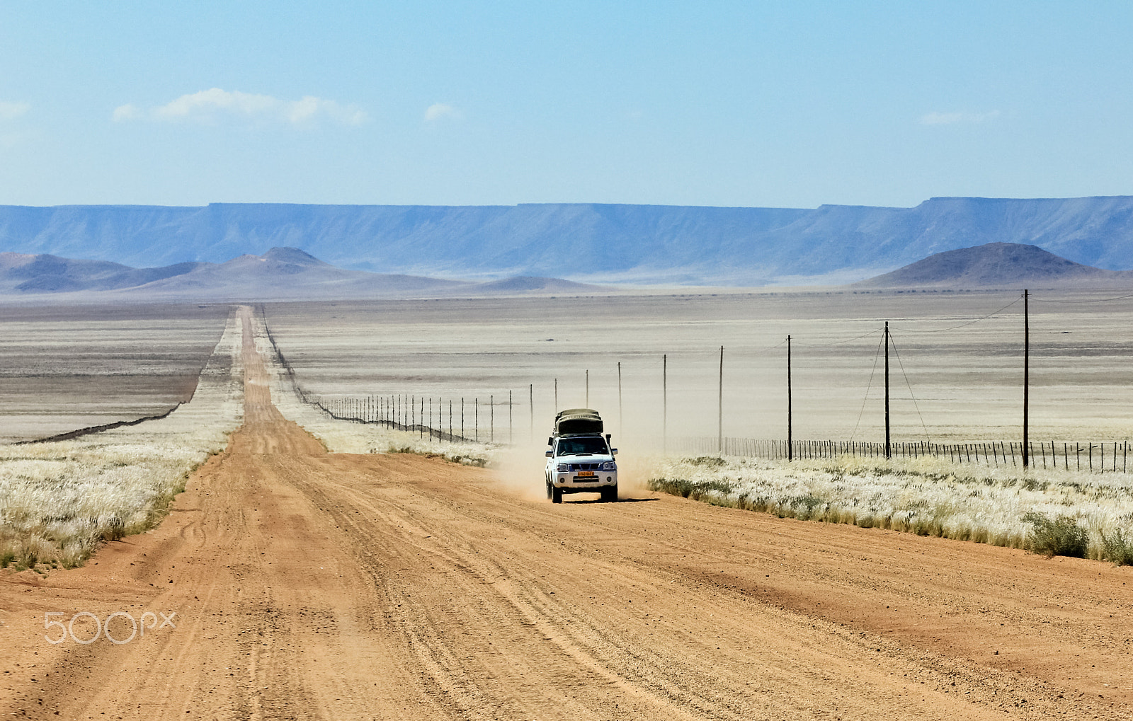Canon EOS 550D (EOS Rebel T2i / EOS Kiss X4) sample photo. Pickup truck driving fast on long straight desert road photography