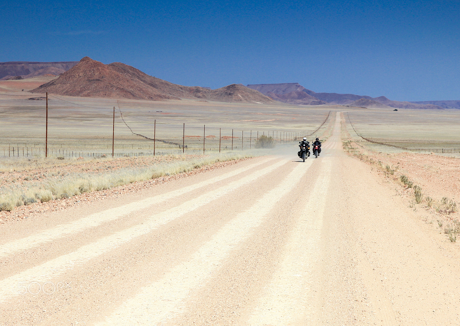 Canon EOS 550D (EOS Rebel T2i / EOS Kiss X4) sample photo. Two motorbikes driving fast on long straight desert road. photography