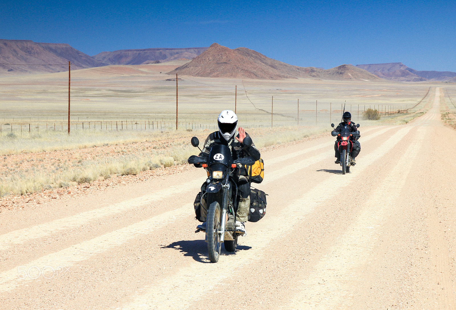 Canon EOS 550D (EOS Rebel T2i / EOS Kiss X4) + Sigma 17-70mm F2.8-4 DC Macro OS HSM | C sample photo. Two motorbikes driving fast on long straight desert road. photography