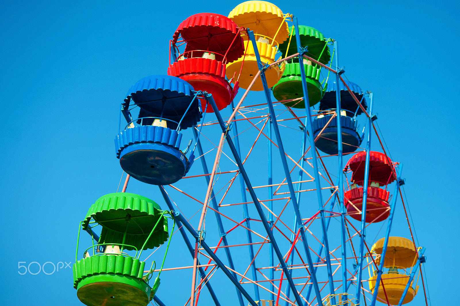 Nikon D700 sample photo. Retro colorful ferris wheel of the amusement park in the blue sky background. photography