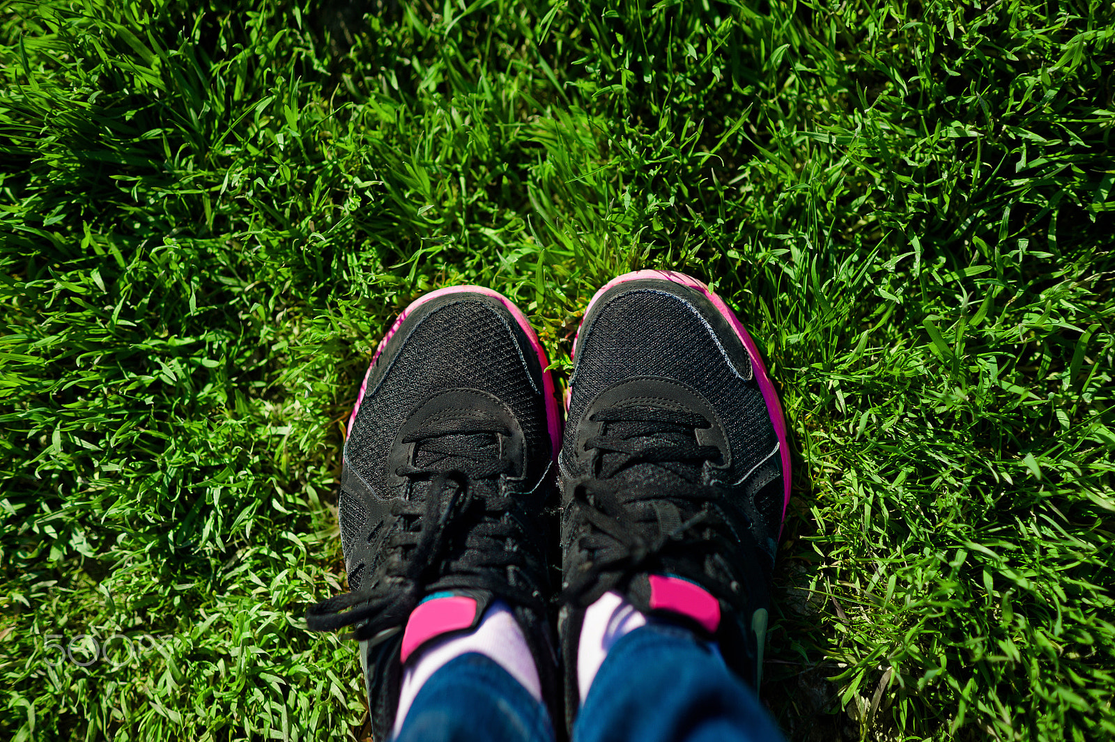 Nikon D700 + Nikon AF Nikkor 85mm F1.8D sample photo. Selfie of female feet on black sneakers standing on green grass photography